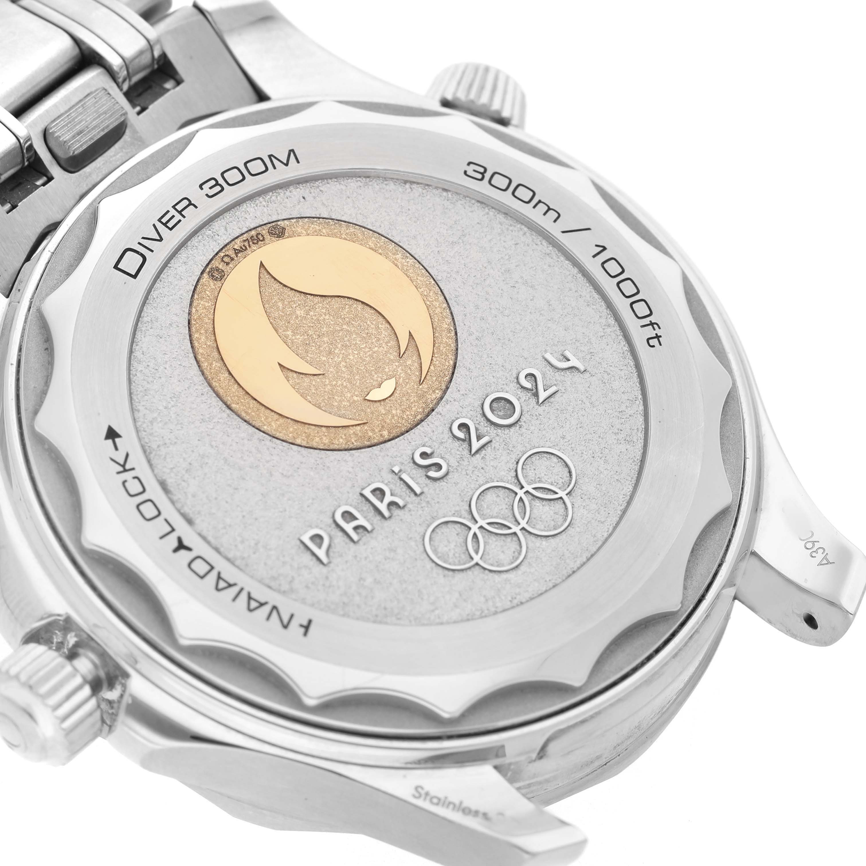 The image shows the back of an Omega Seamaster 522.21.42.20.04.001 Men's Stainless Steel White Dial watch, featuring the Paris 2024 emblem and "Diver 300M" inscription.