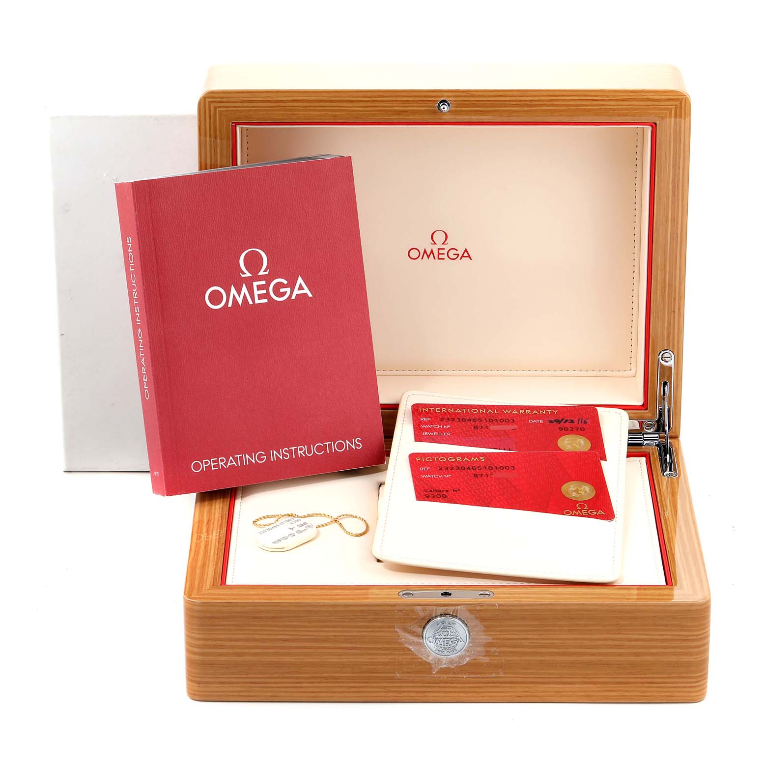 The image shows the accessories for the Omega Planet Ocean 232.30.46.51.01.003 Men's Stainless Steel Black Dial 232.30.46.51.01.003 Men's Stainless Steel Black Dial watch, including the box, manuals, and warranty cards, from a front angle.