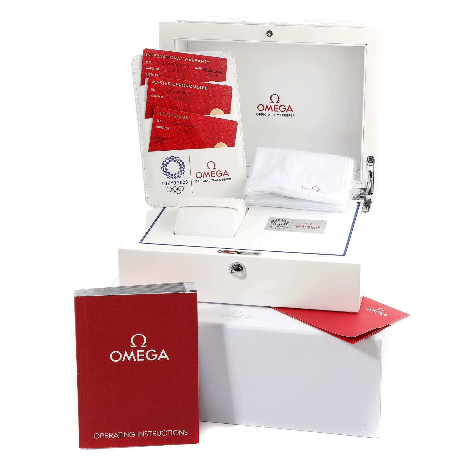 The image shows a box with Omega branding, containing cards, a cleaning cloth, a case, and an operating instructions manual for the Seamaster model.