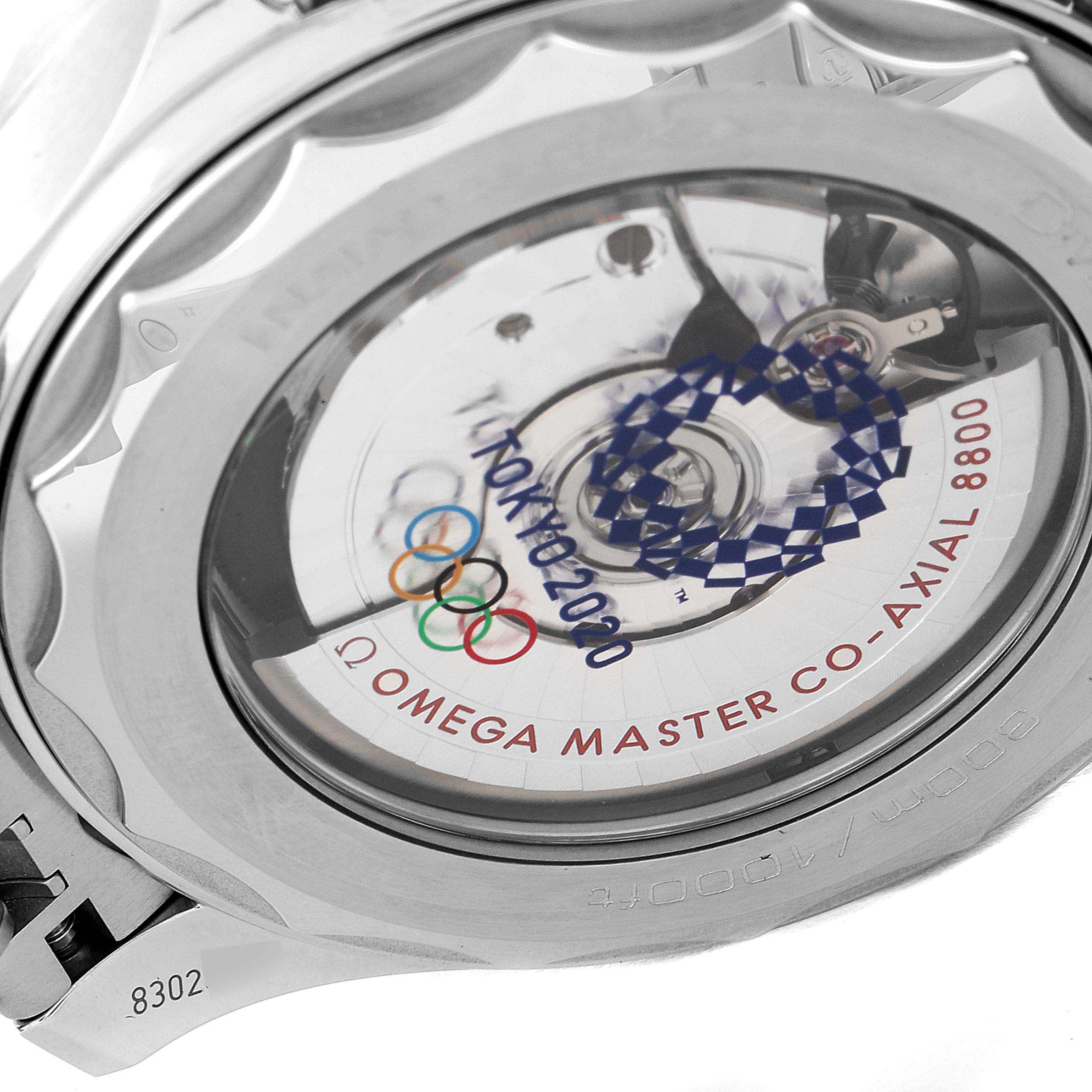 The image shows the case back of the Omega Seamaster 522.30.42.20.04.001 Men's Stainless Steel White Dial 522.30.42.20.04.001 Men's Stainless Steel White Dial watch, featuring the exposed movement and Tokyo 2020 Olympics engraving.