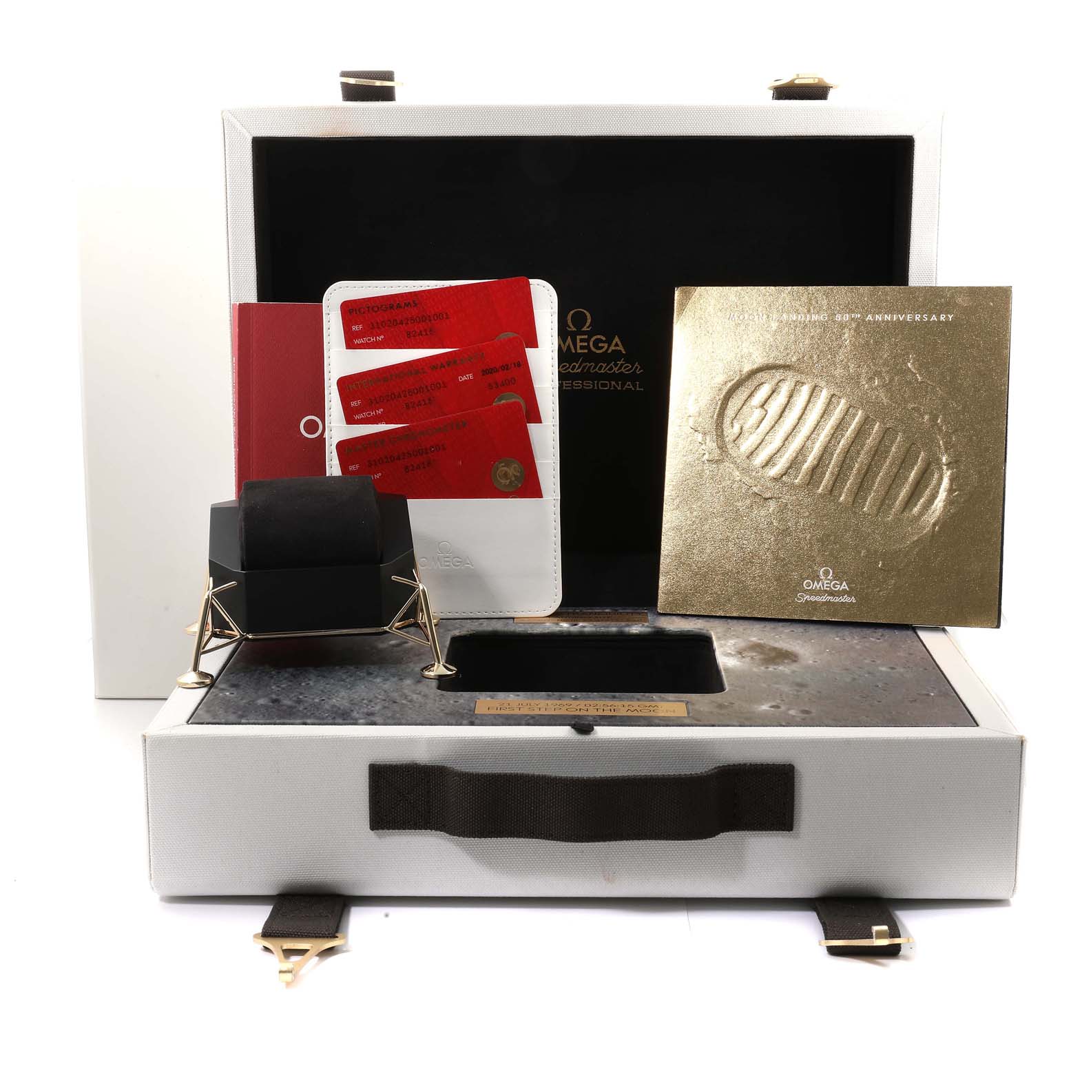 The image shows the accessories and packaging for an Omega Speedmaster 310.20.42.50.01.001 Men's Stainless Steel Grey Dial 310.20.42.50.01.001 Men's Stainless Steel Grey Dial, including cards, a booklet, and a presentation box.