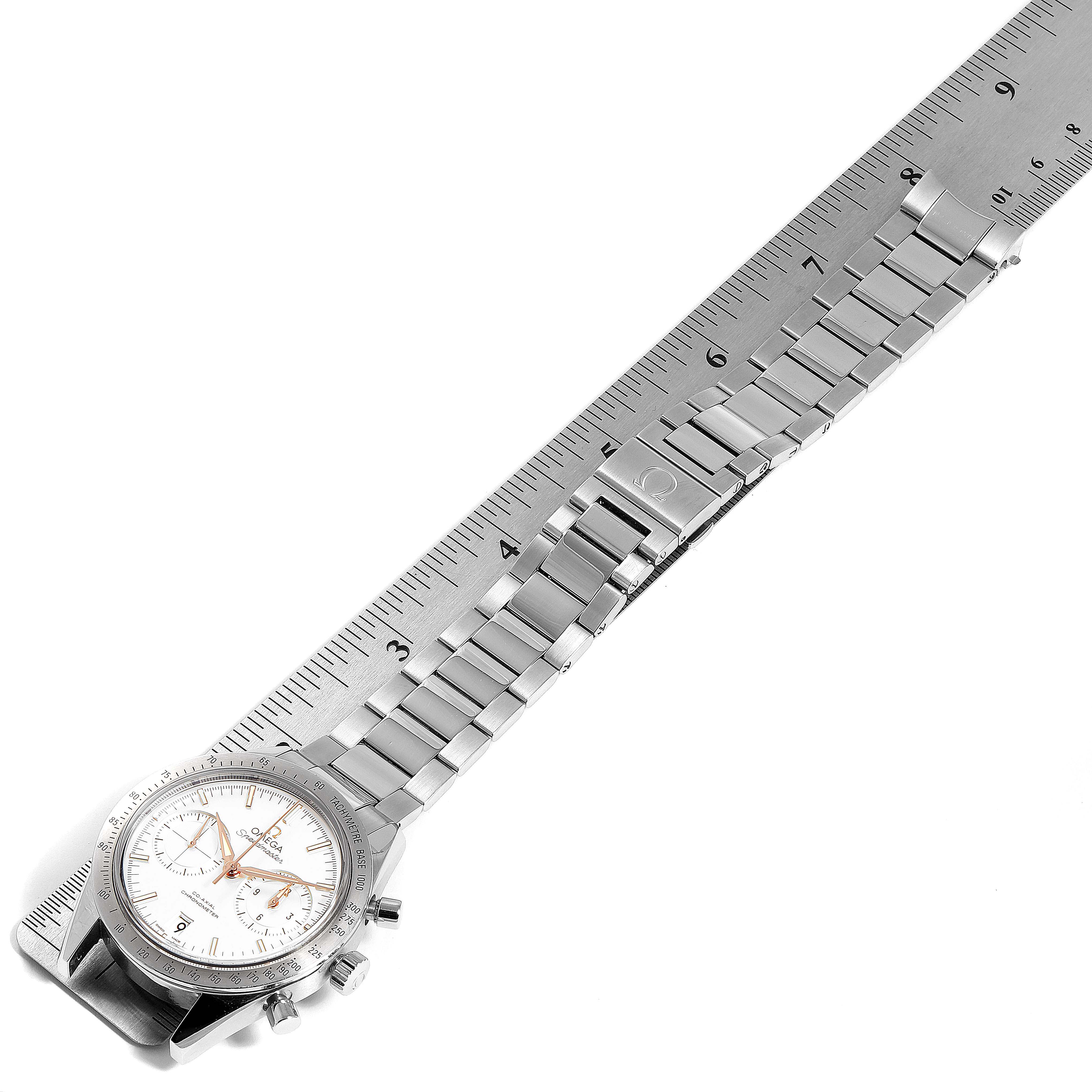 The Omega Speedmaster 331.10.42.51.02.002 Men's Stainless Steel Silver Dial 331.10.42.51.02.002 Men's Stainless Steel Silver Dial watch is displayed from an overhead angle along with a measuring ruler, showing its bracelet and case.