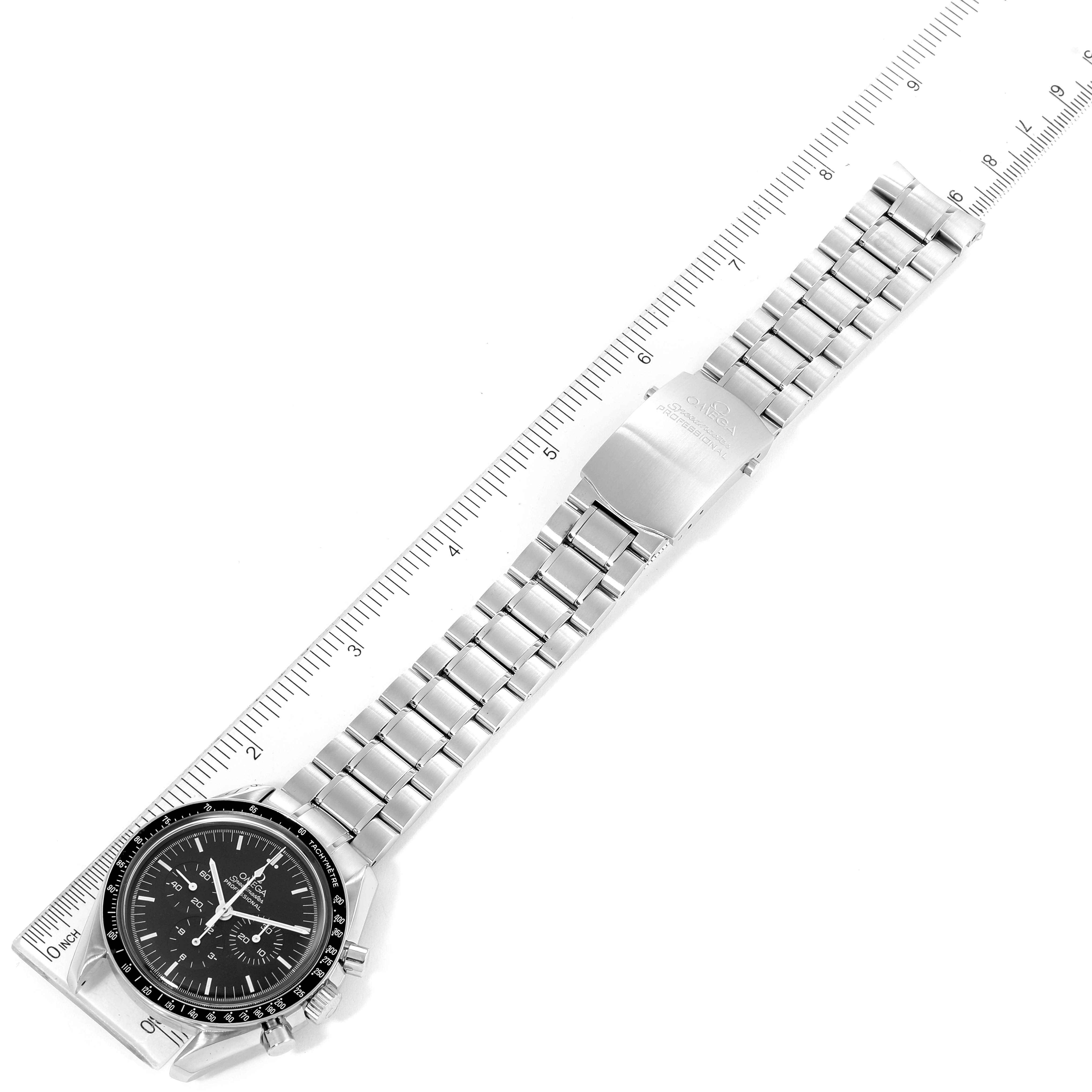 The image shows an Omega Speedmaster 3572.50.00 Men
s Stainless Steel Black Dial 3572.50.00 Men
s Stainless Steel Black Dial watch laid flat with the entire strap and face visible alongside a measuring ruler.