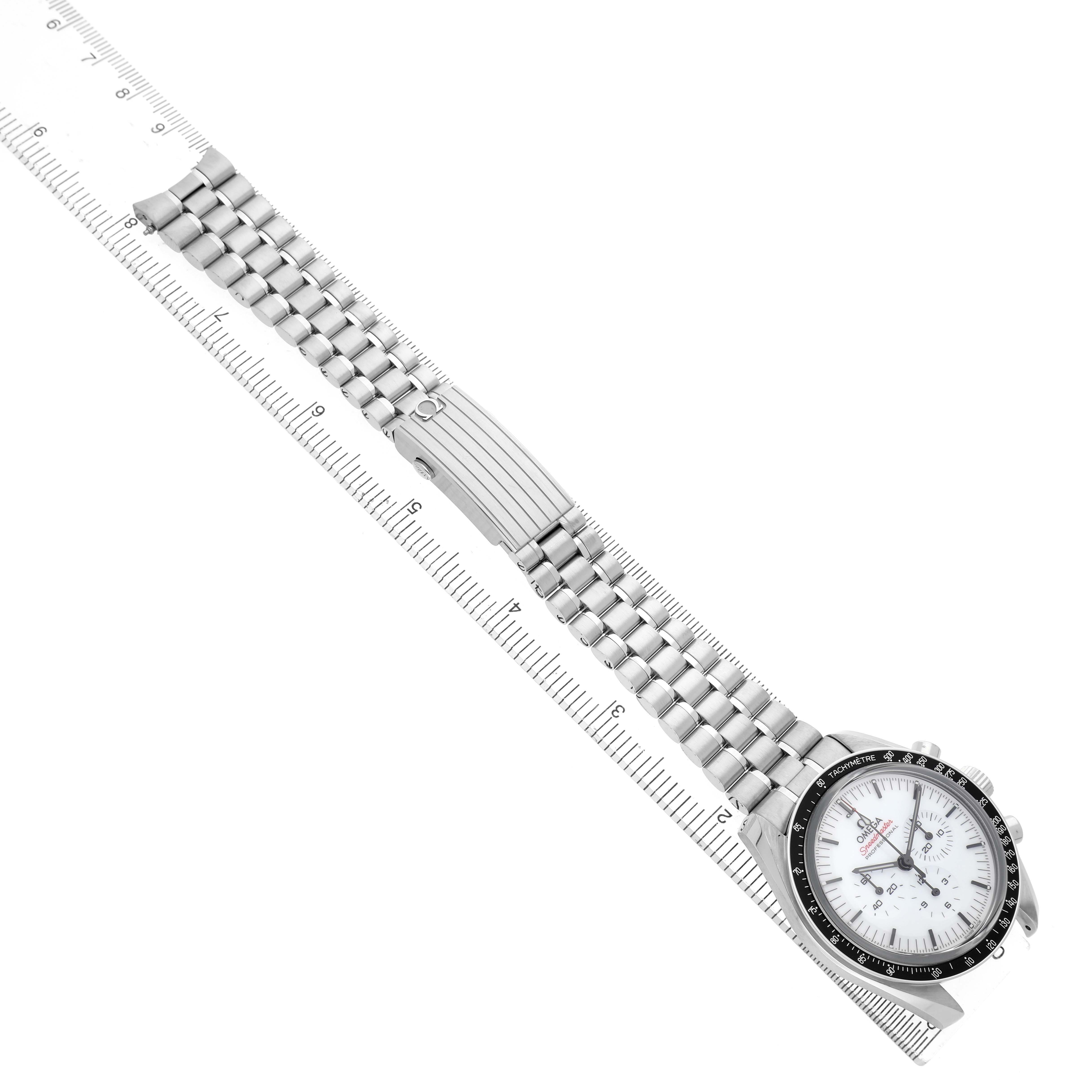 The Omega Speedmaster 310.30.42.50.04.001 Men's Stainless Steel White Dial watch is shown diagonally with its full bracelet and face visible, alongside a ruler for scale.