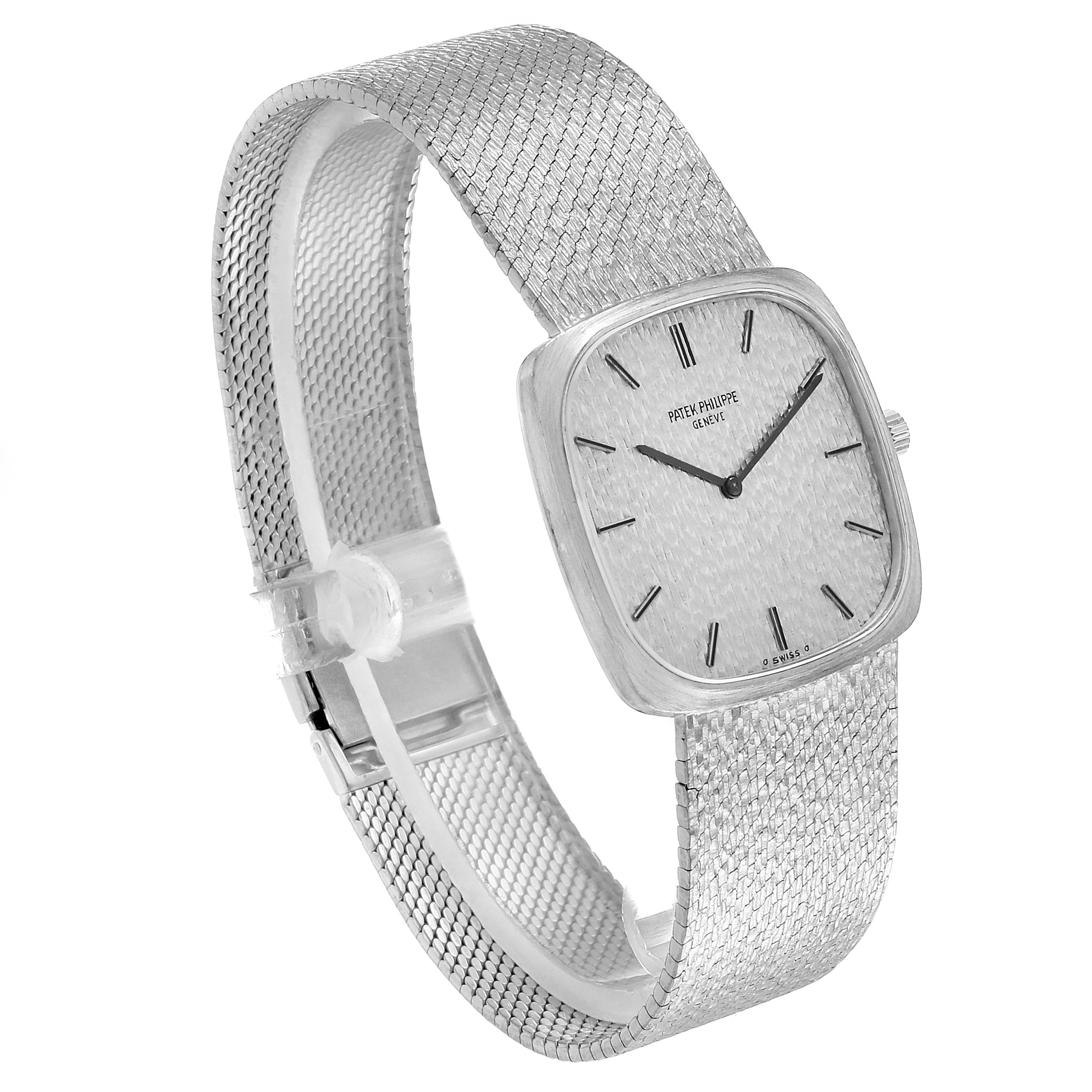 The image shows a side-angle view of a Vintage Patek Philippe watch, highlighting its mesh strap, square face, and dial.