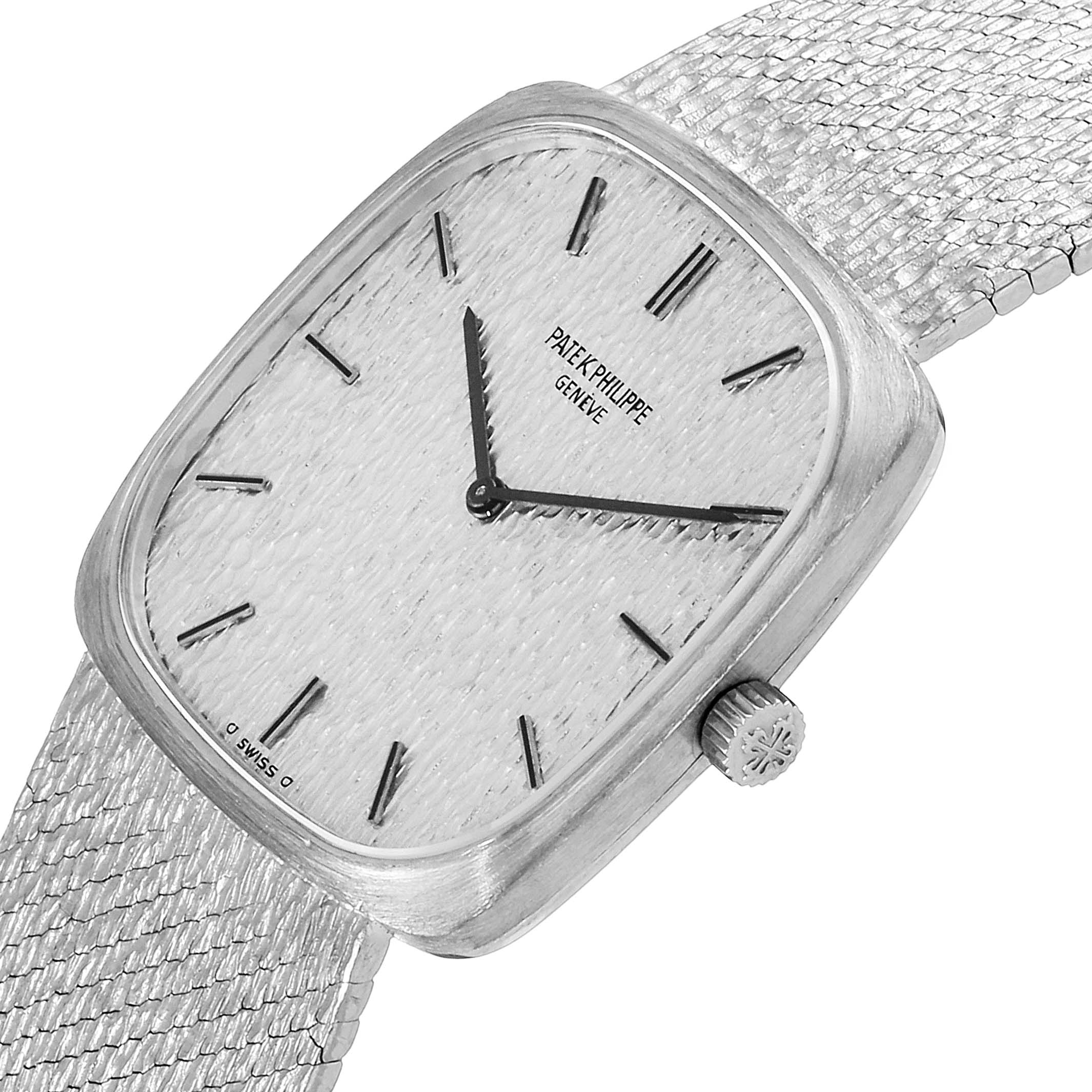 The image shows a close-up, angled view of a Vintage Patek Philippe watch, highlighting its dial, hands, and textured bracelet.