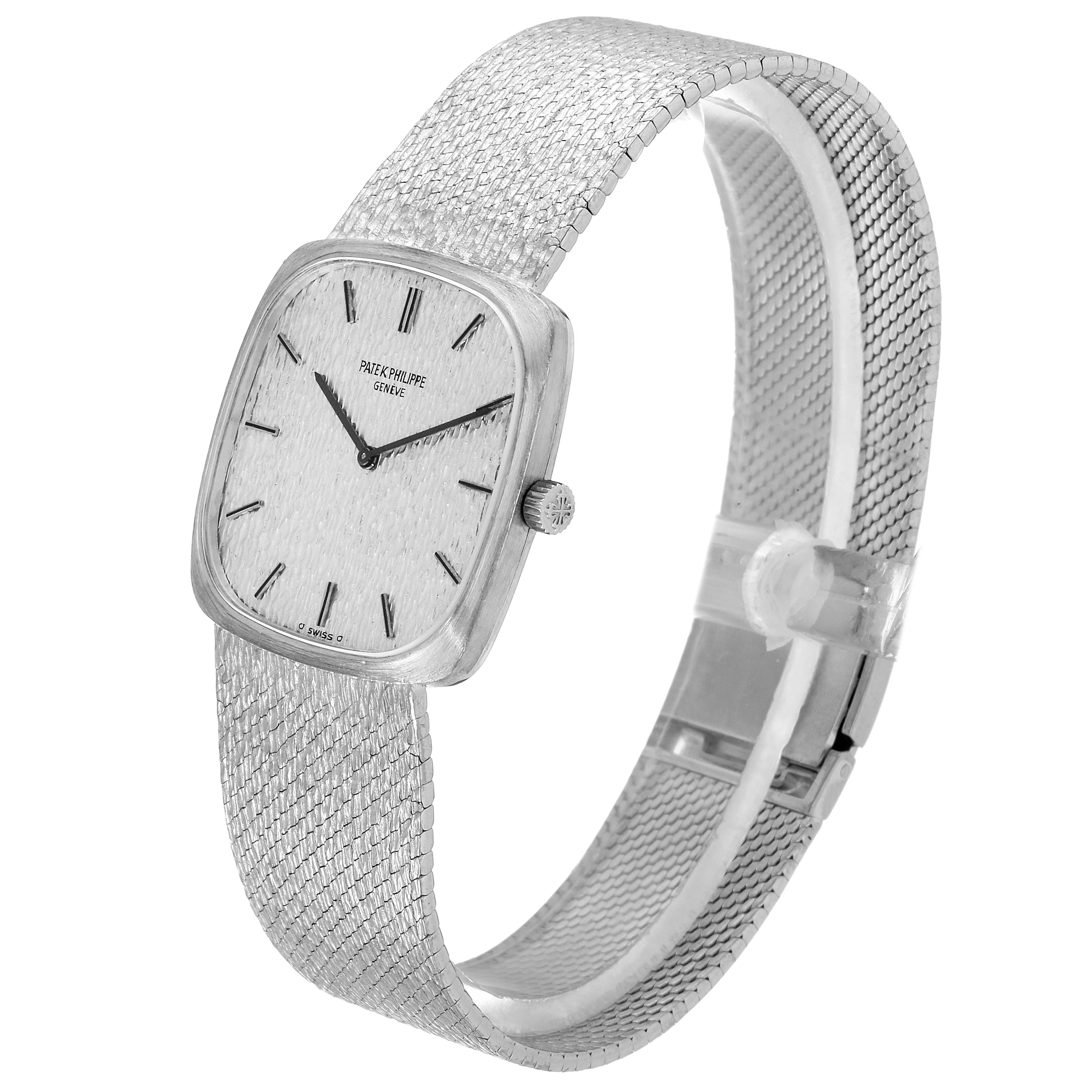 This image shows a side angle of a Vintage Patek Philippe watch, displaying its mesh strap and rectangular watch face.