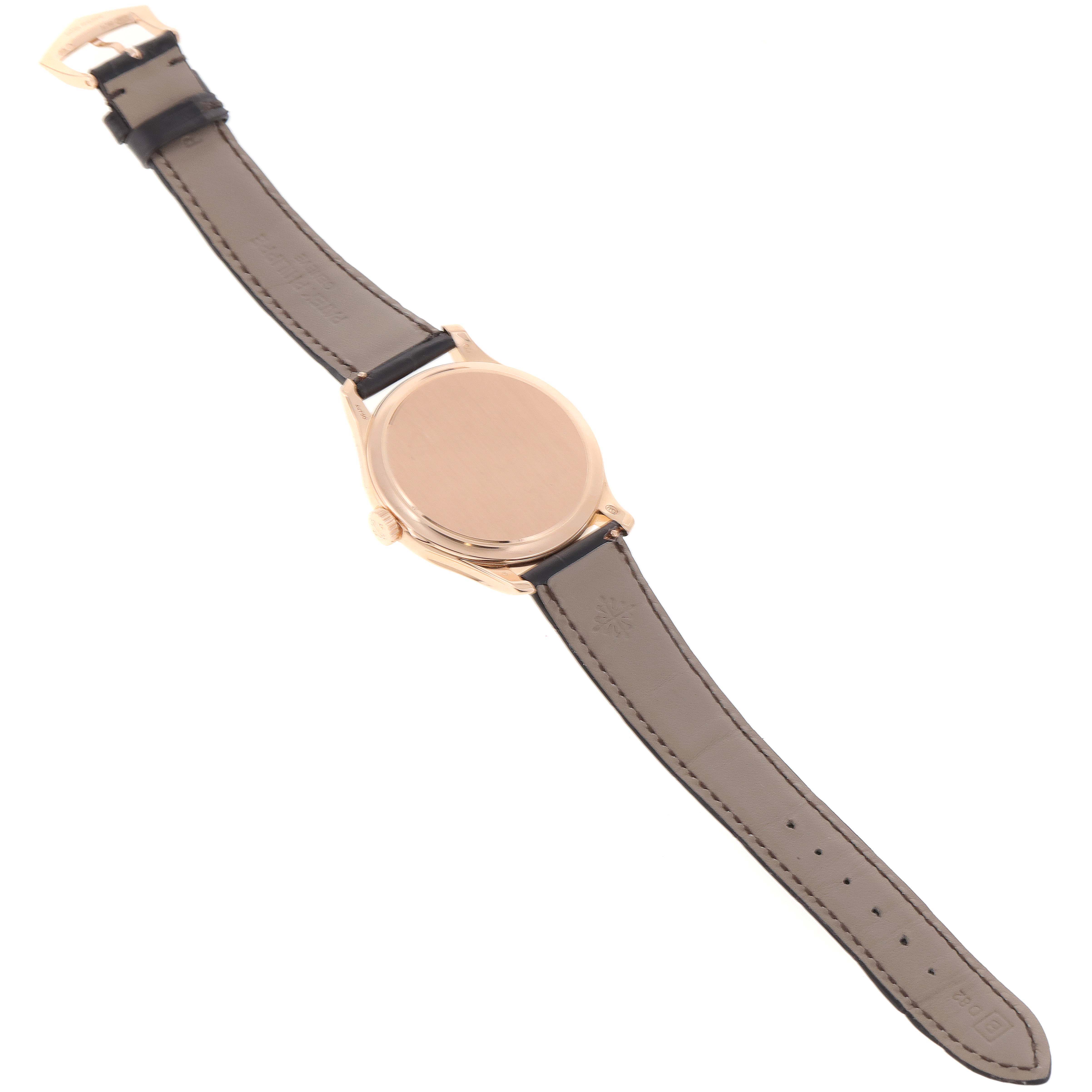 The Patek Philippe Calatrava 5227R-001 Men's Rose Gold Beige Dial 5227R-001 Men's Rose Gold Beige Dial watch is shown from the back, displaying the case and leather strap.