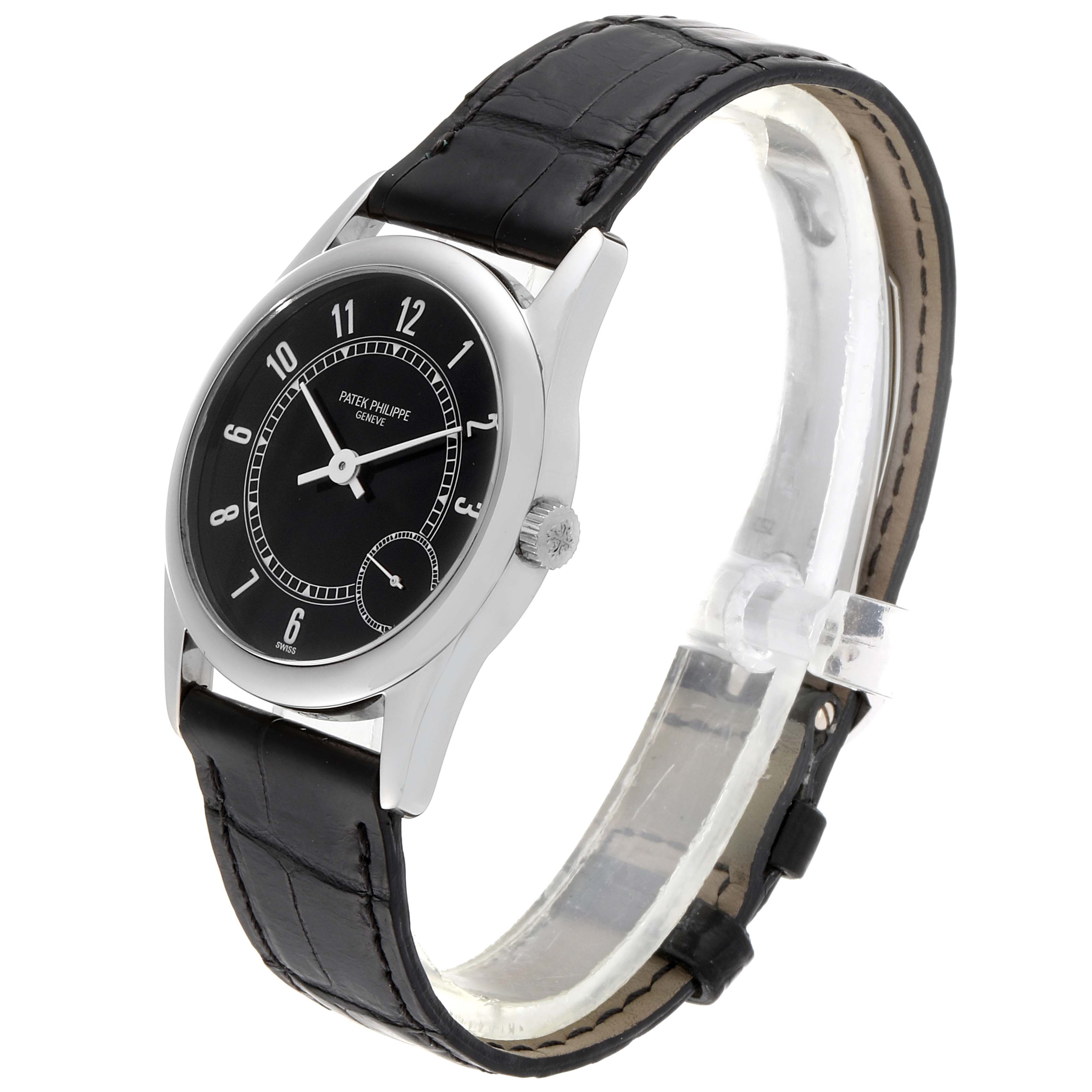 The image shows a Patek Philippe Calatrava 5000G Men's White Gold Black Dial 5000G Men's White Gold Black Dial watch at a three-quarter angle, displaying its black dial, lugs, and leather strap.