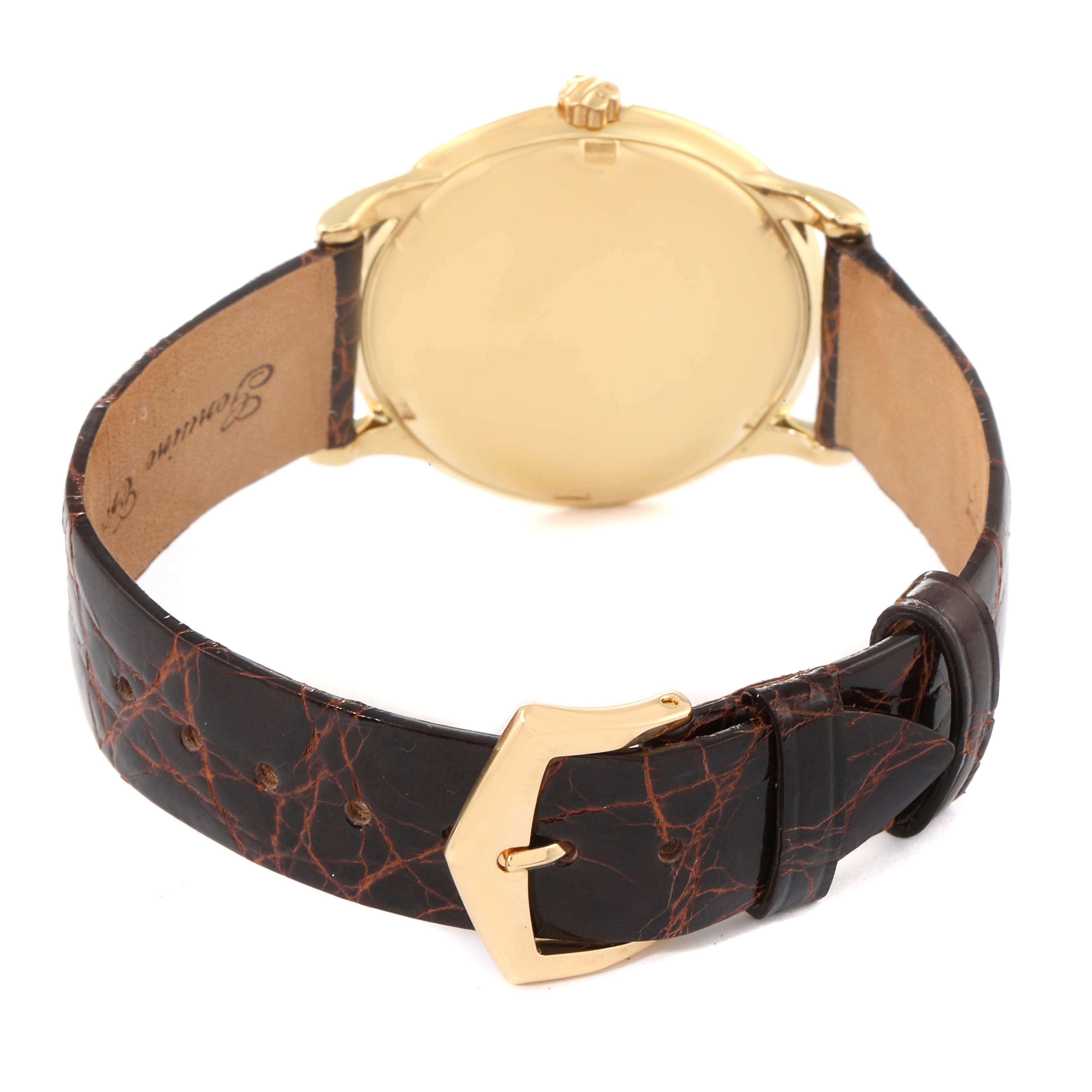 The image shows the back of a Patek Philippe Vintage watch with a brown leather strap and gold buckle.