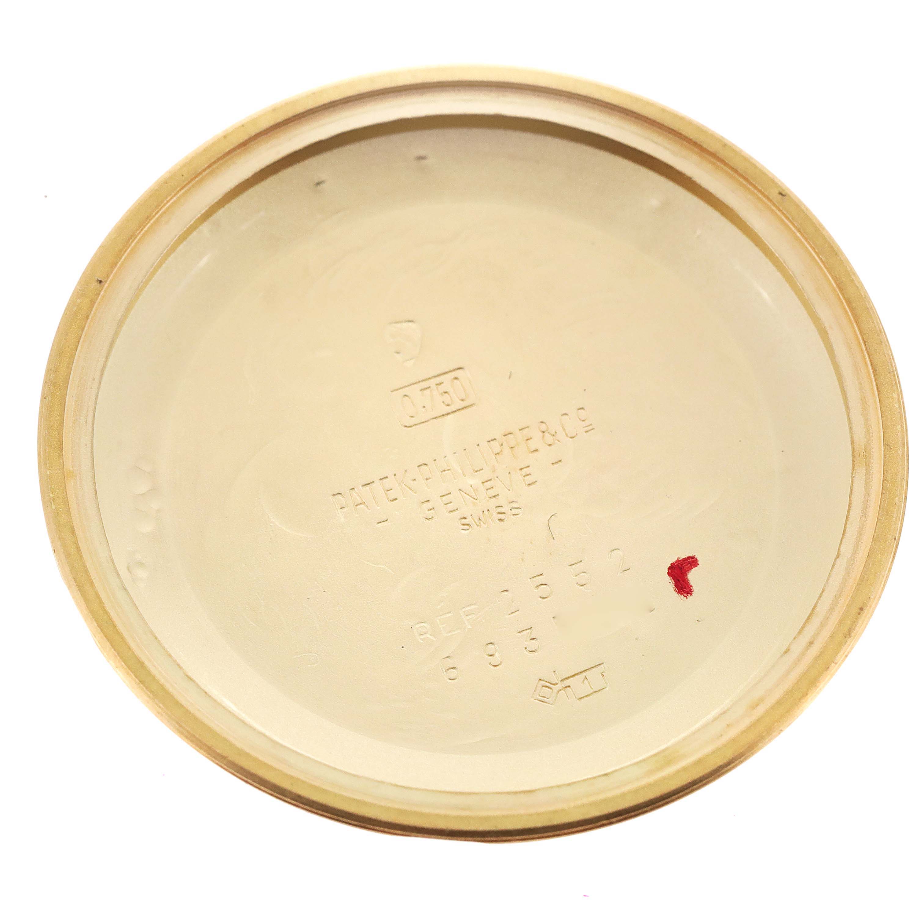 This image shows the inside of the case back of a vintage Patek Philippe watch, displaying the brand, model reference, and other markings.