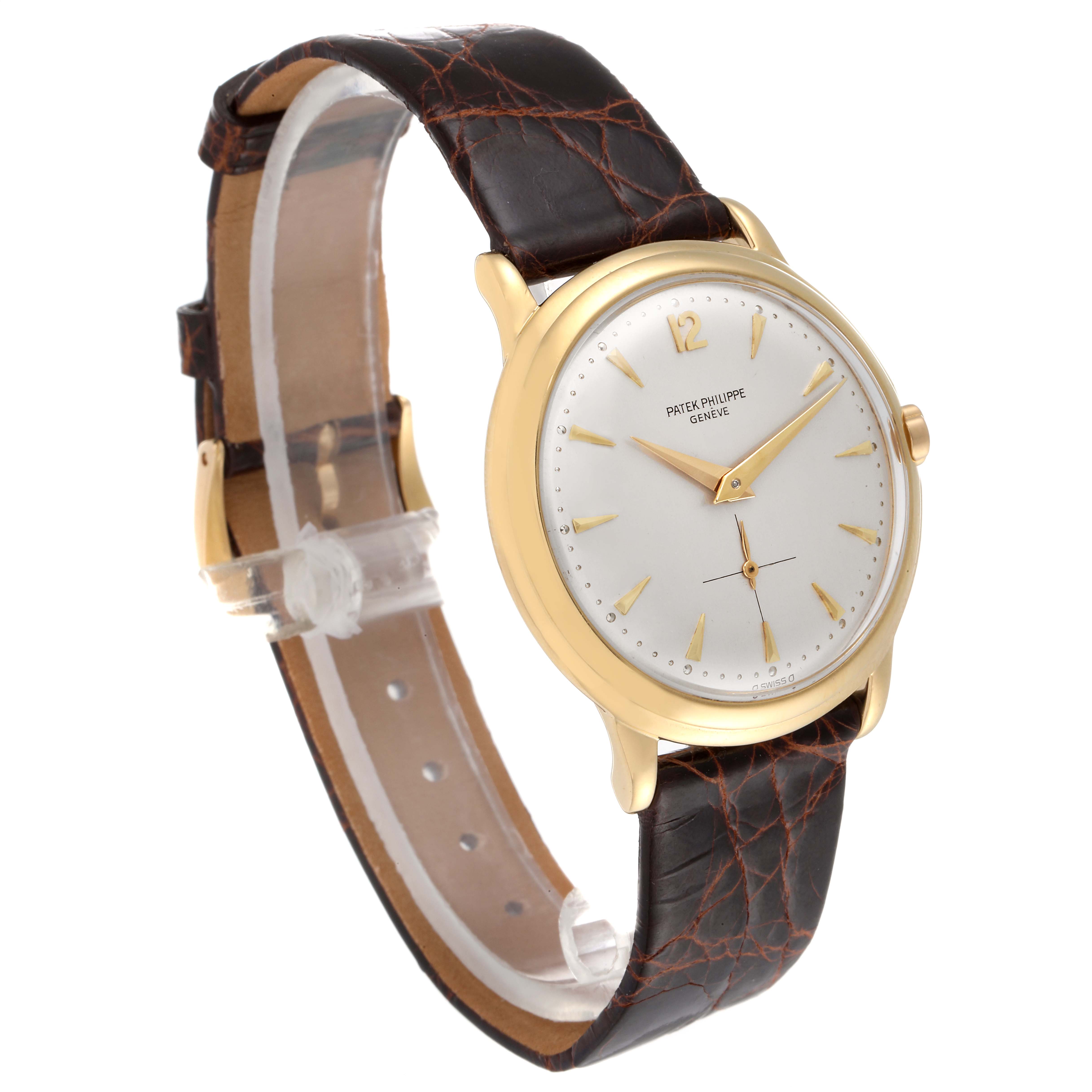 The image shows a Patek Philippe Vintage watch from an angled side view, highlighting its face, gold case, and brown leather strap.