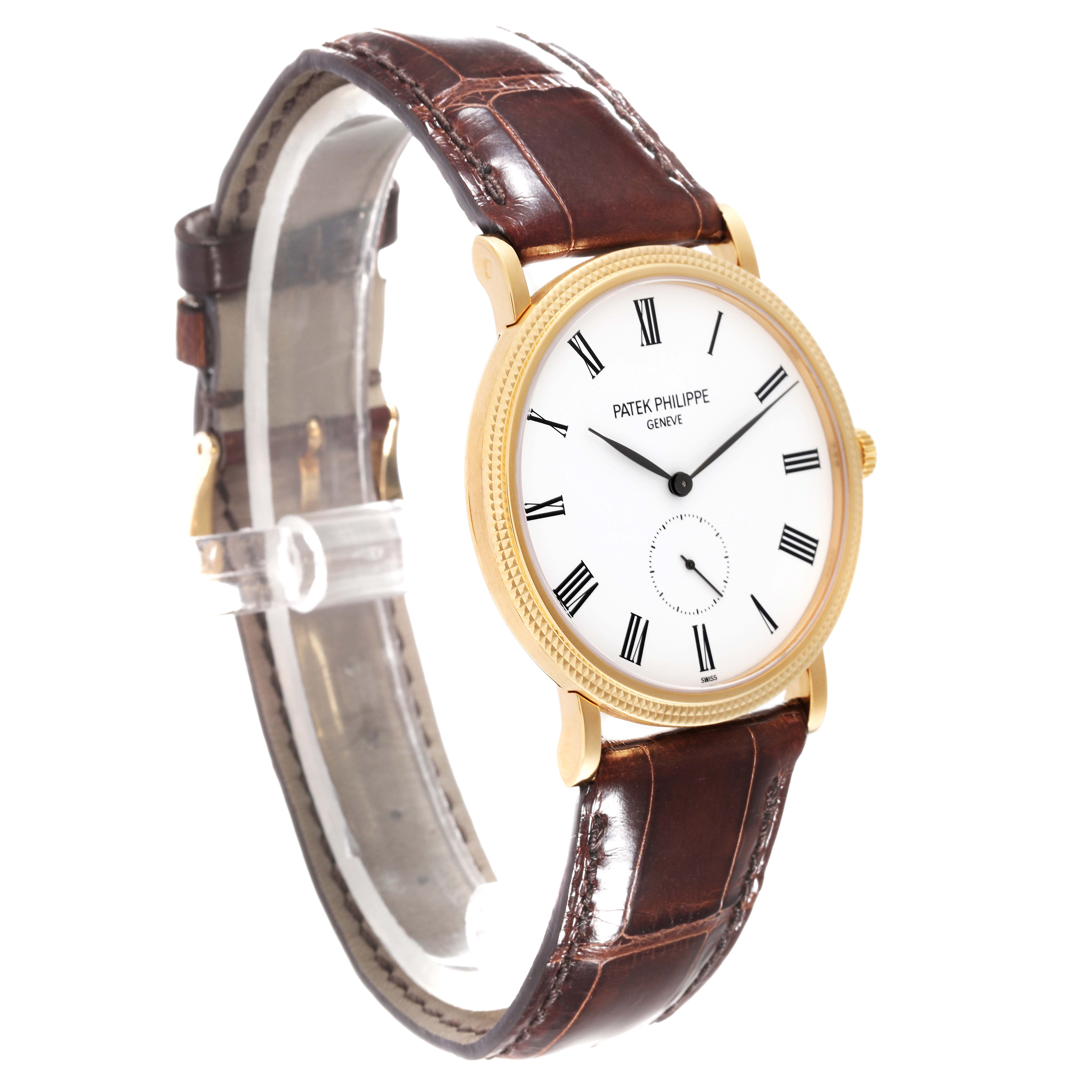 The image shows a Patek Philippe Calatrava 5119J-001 Men's Yellow Gold White Dial 5119J-001 Men's Yellow Gold White Dial watch at a front-side angle, displaying the dial and brown leather strap.