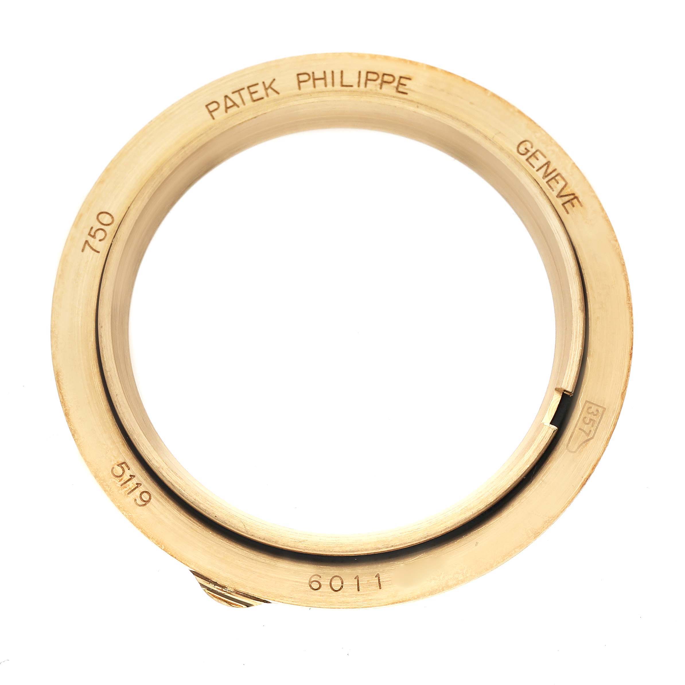 This image shows a close-up of a circular bezel or case part for a Patek Philippe Calatrava 5119J-001 Men's Yellow Gold White Dial 5119J-001 Men's Yellow Gold White Dial watch.