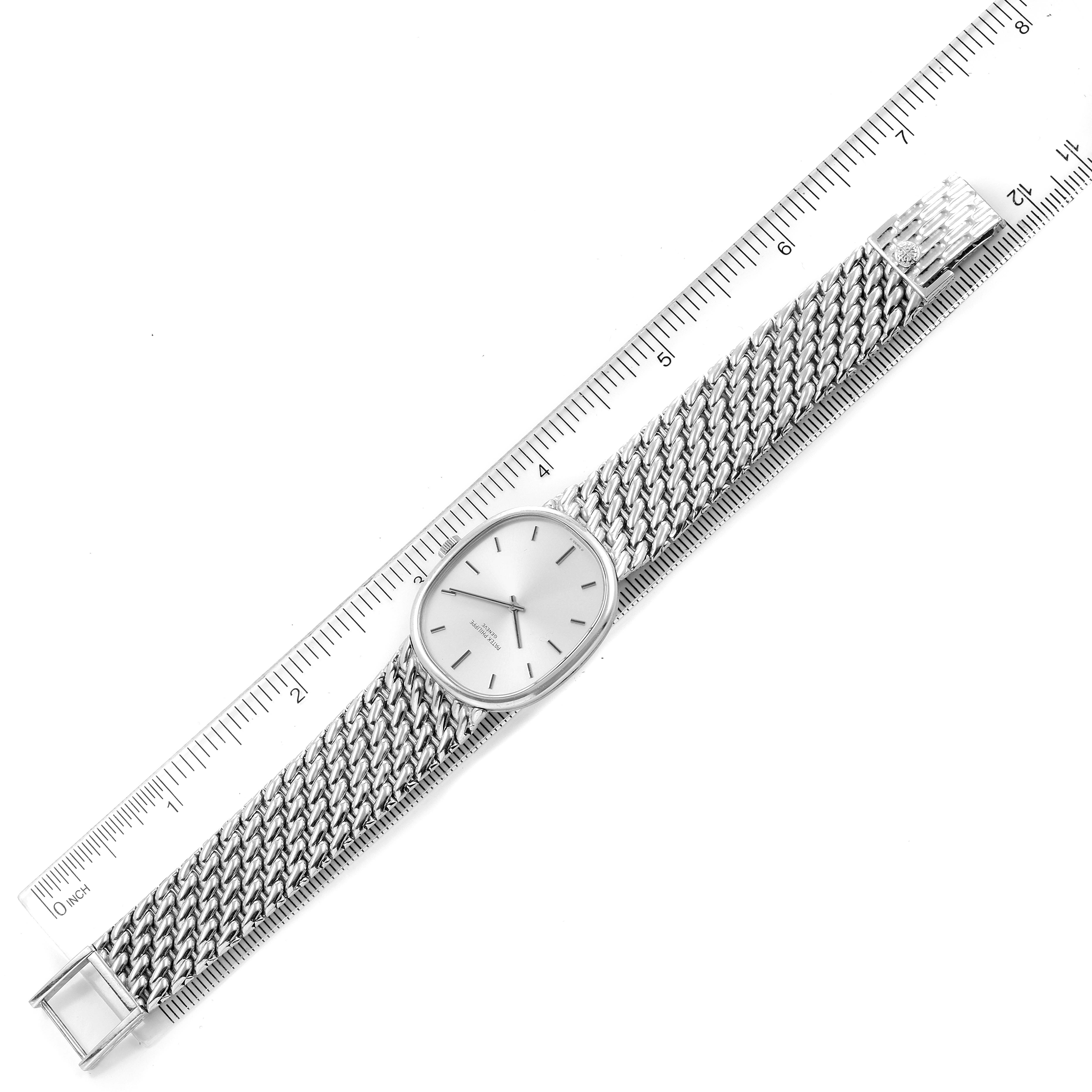 The image shows a Patek Philippe Golden Ellipse 3848 Men's White Gold Silver Dial 3848 Men's White Gold Silver Dial watch lying flat with both the face and bracelet displayed alongside a ruler for scale.