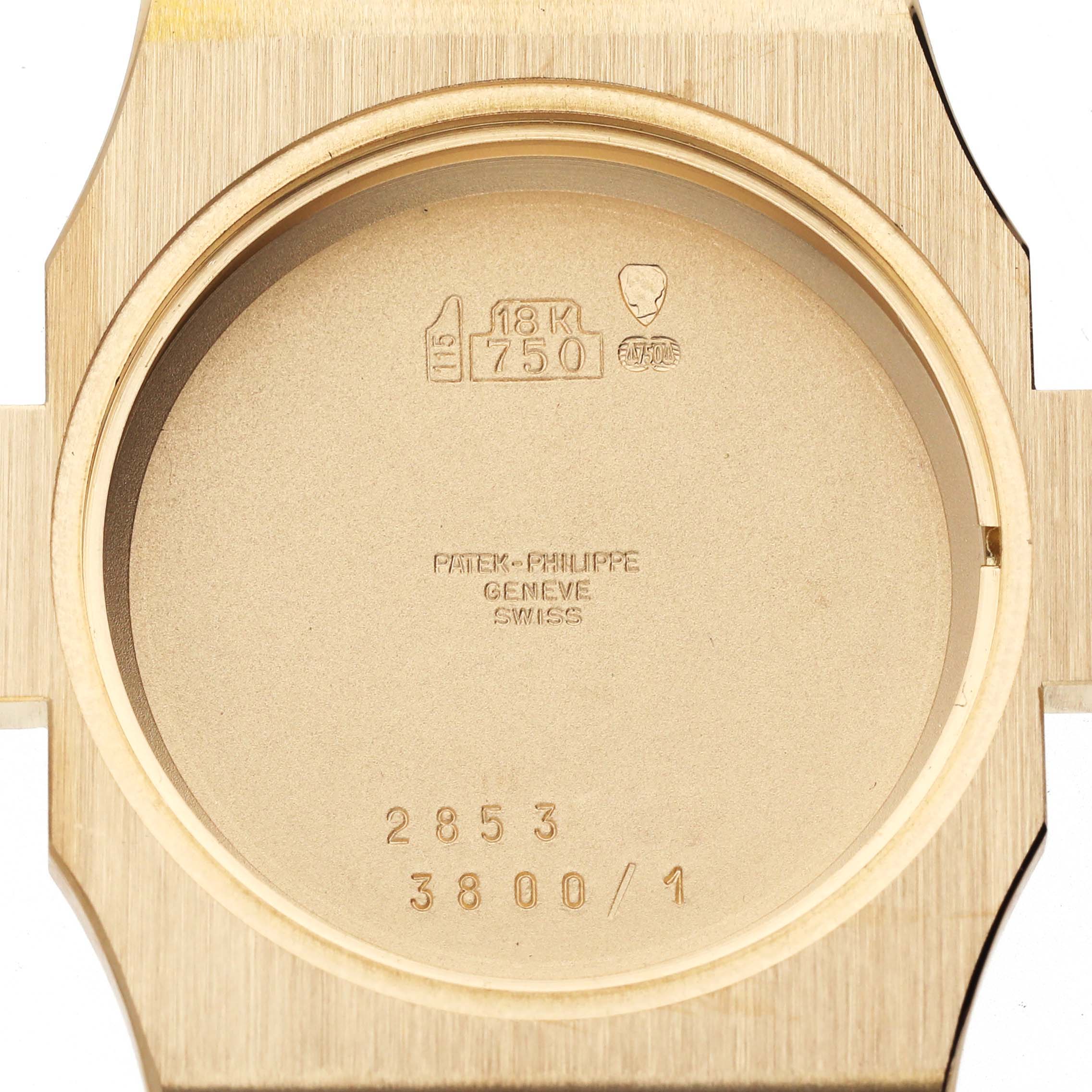 This image shows the back case of the Patek Philippe Nautilus 3800/1J Men's Yellow Gold White Dial 3800/1J Men's Yellow Gold White Dial watch, highlighting markings and engravings inside the case.