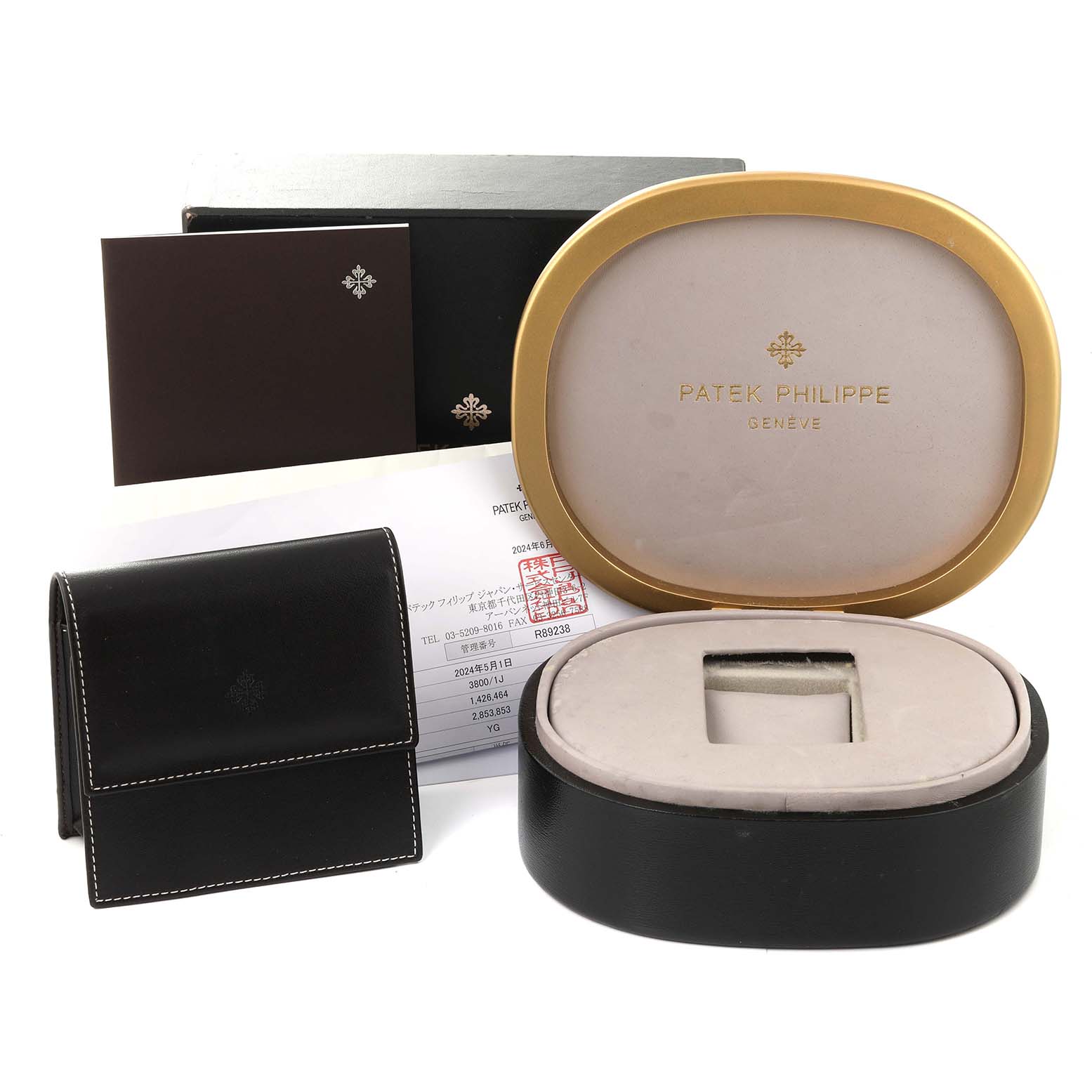 This image shows the packaging and accessories for a Patek Philippe Nautilus 3800/1J Men's Yellow Gold White Dial 3800/1J Men's Yellow Gold White Dial watch, including the box, case, and documents.