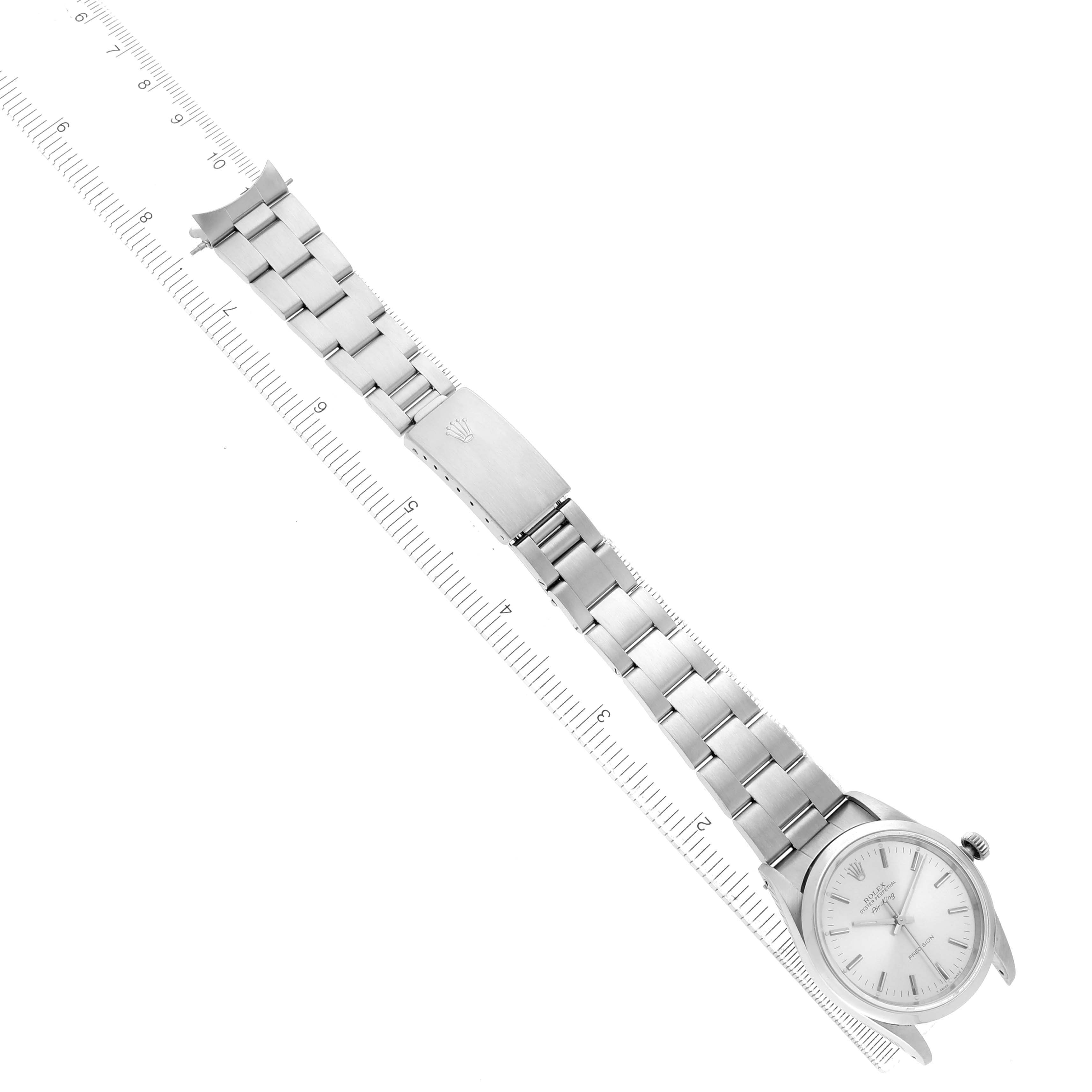 The Rolex Air-King 14000 Men's Stainless Steel Silver Dial watch is shown from a top-down angle, displaying the full bracelet and face, alongside a ruler for scale.