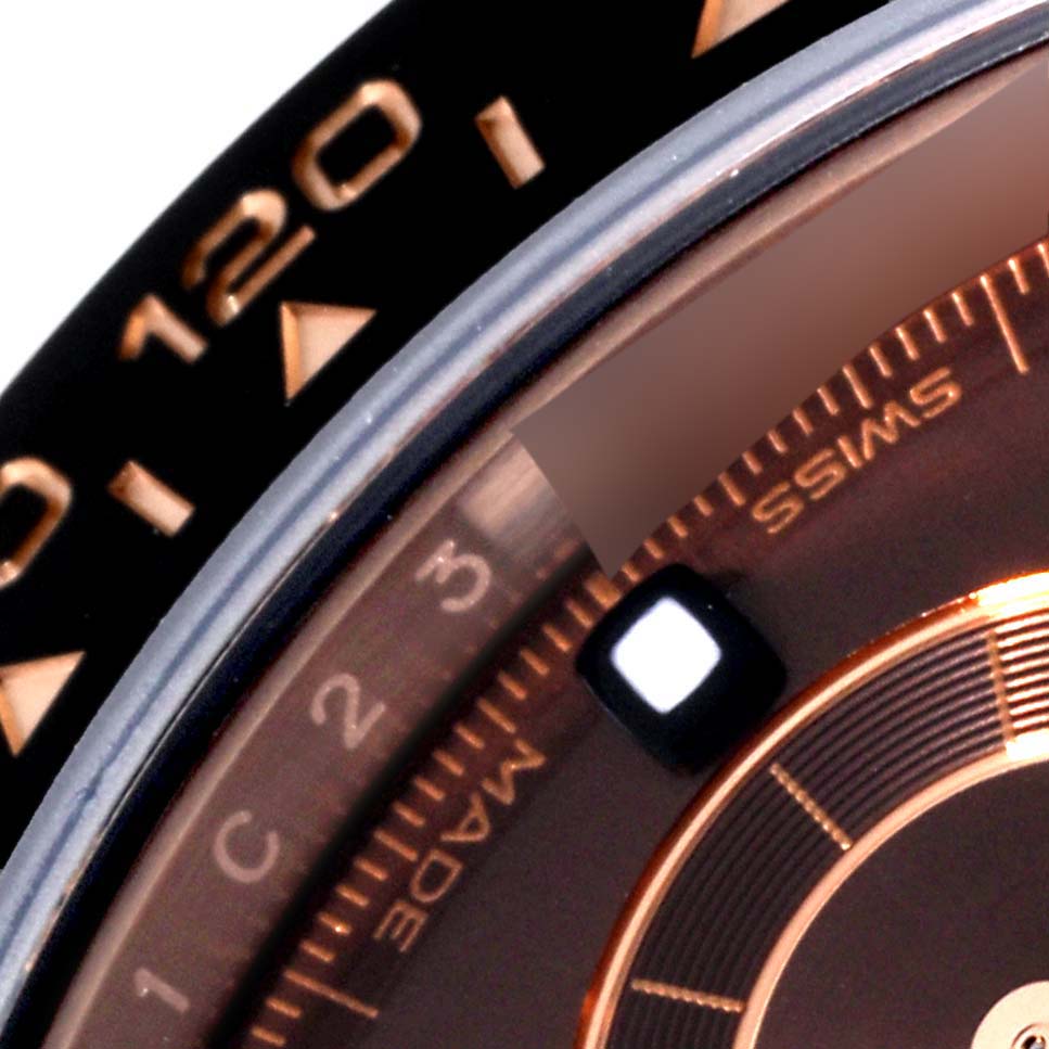 This close-up of the Rolex Daytona 116515 Men's Rose Gold Black Dial 116515 Men's Rose Gold Black Dial shows the bezel, part of the dial, and the "Swiss Made" text.