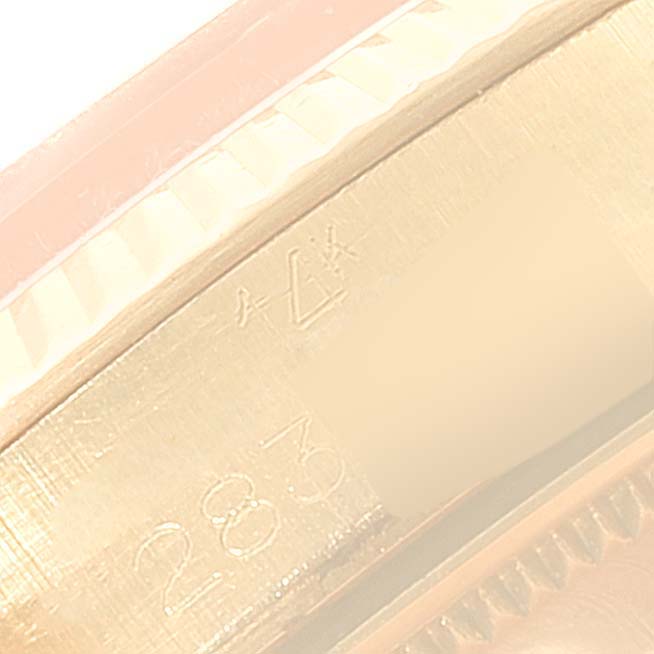This image shows a close-up of the side of the Vintage Collection model by Rolex, highlighting the engraved serial number and edge of the bezel.