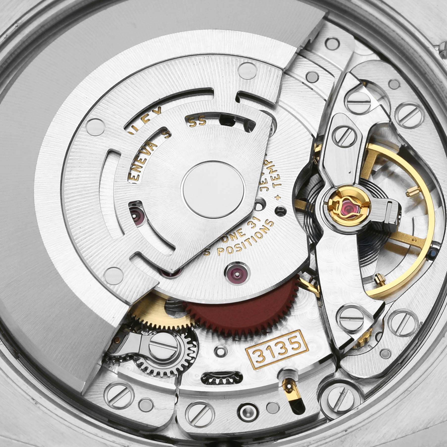 This image shows the intricate movement mechanism inside a Rolex Date 115234 Men's Stainless Steel Silver Dial 115234 Men's Stainless Steel Silver Dial model watch, highlighting gears and other internal components.
