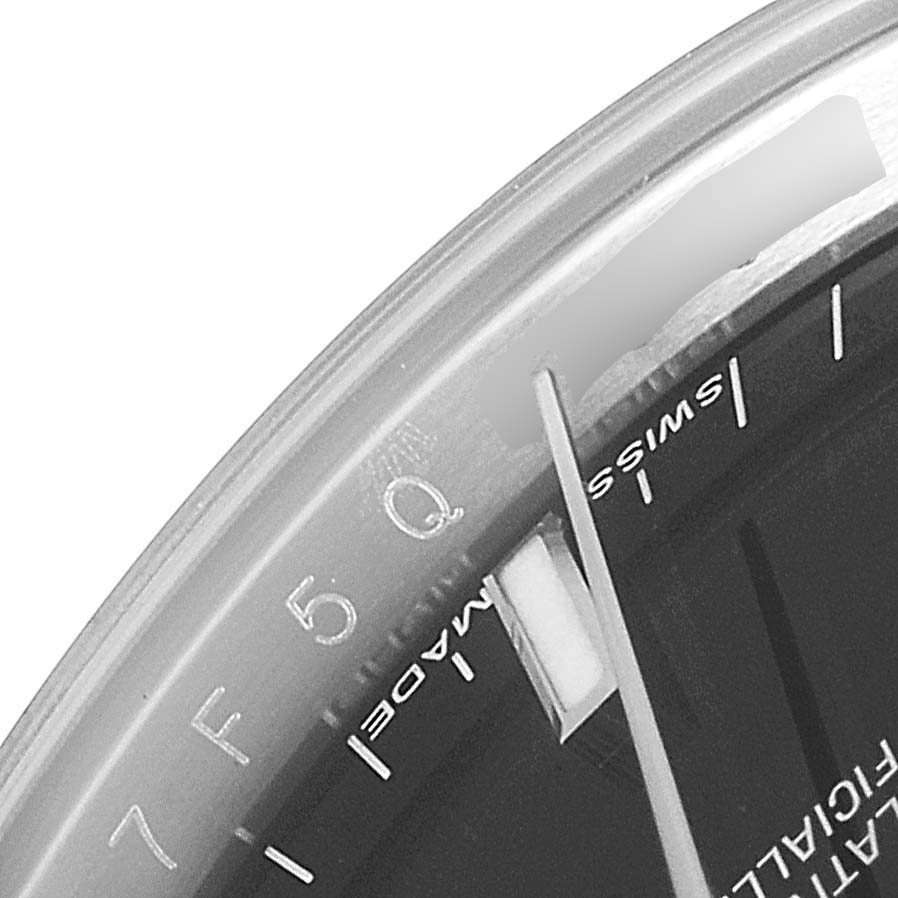 This image shows a macro view of the dial and part of the watch face on a Rolex Date 115200 Men's Stainless Steel Black Dial 115200 Men's Stainless Steel Black Dial model, highlighting the "Swiss Made" text.