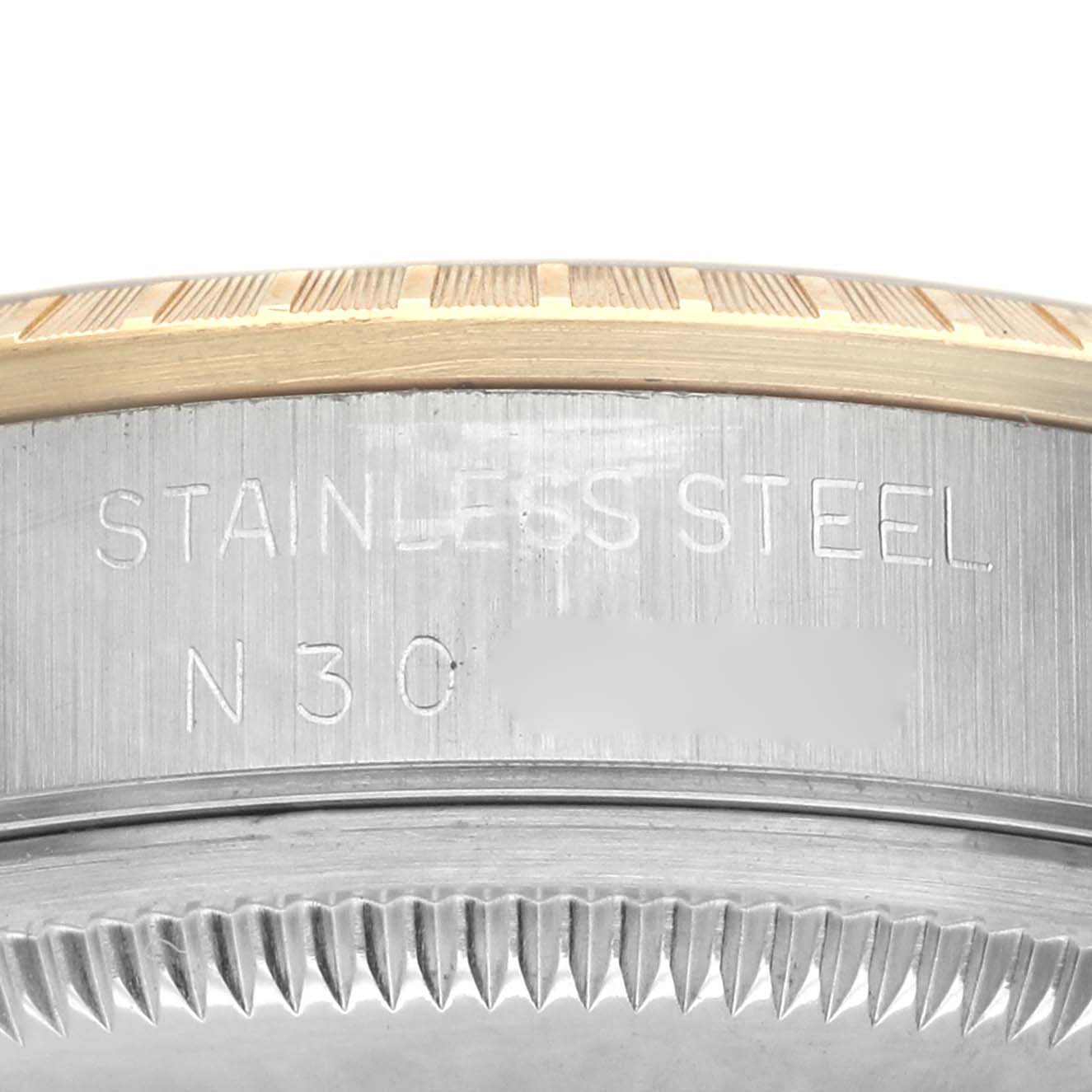 The image shows a close-up of the side of a Rolex Date 15223 Men's Steel and Gold (two tone) Champagne Dial model, highlighting the stainless steel case and the fluted bezel.