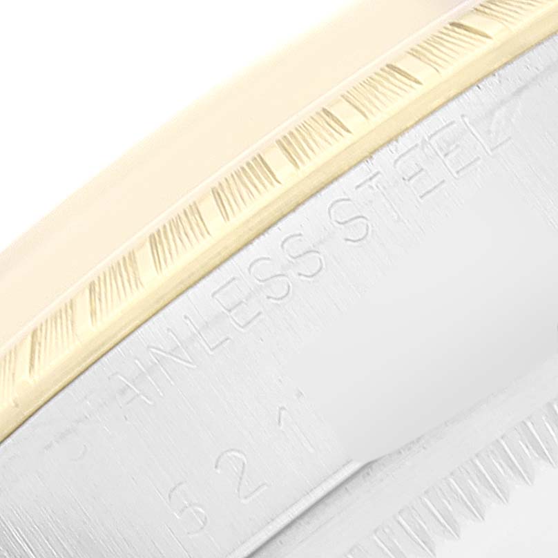 This close-up image shows the side view of the bezel and case of the Rolex Vintage Collection 1505 Men
s Steel and Gold (two tone) Champagne Dial 1505 Men
s Steel and Gold (two tone) Champagne Dial watch, highlighting the "Stainless Steel" engraving.