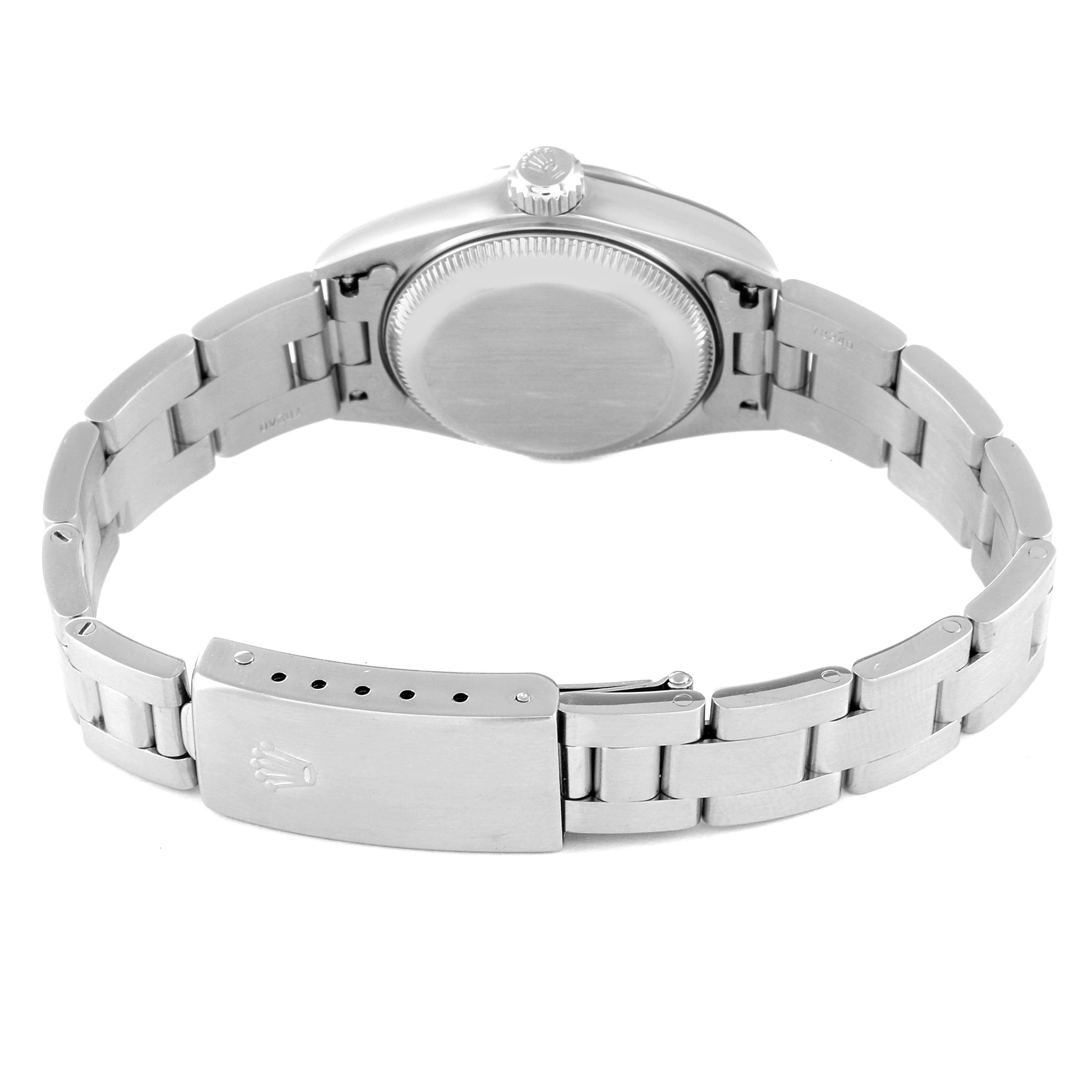 This image shows the backside view of a Date model by Rolex, featuring the case back and the bracelet with the clasp.