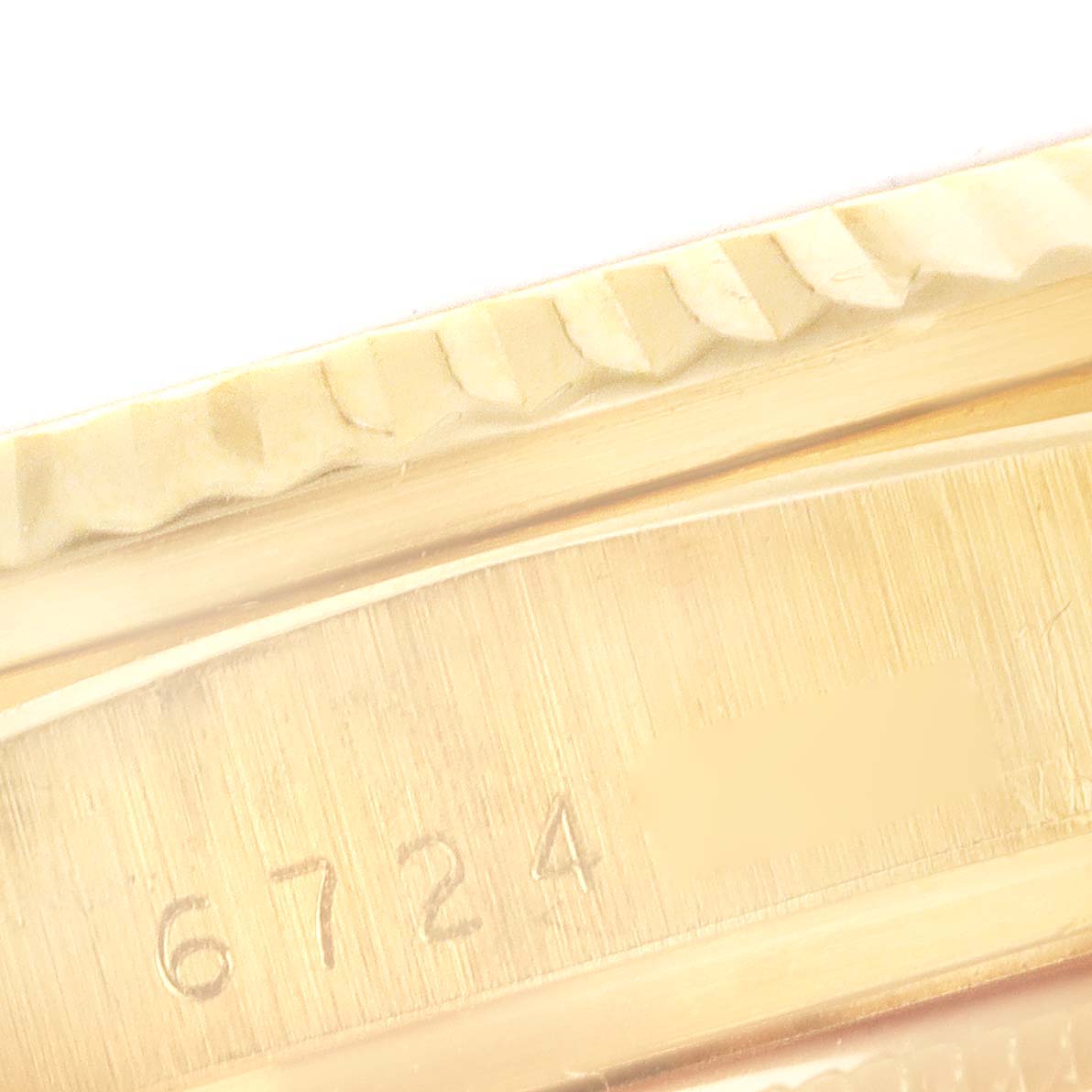This close-up image shows the serial number area of a Rolex President 16018 Men's Yellow Gold Blue Dial 16018 Men's Yellow Gold Blue Dial model, highlighting part of the bezel and casing.