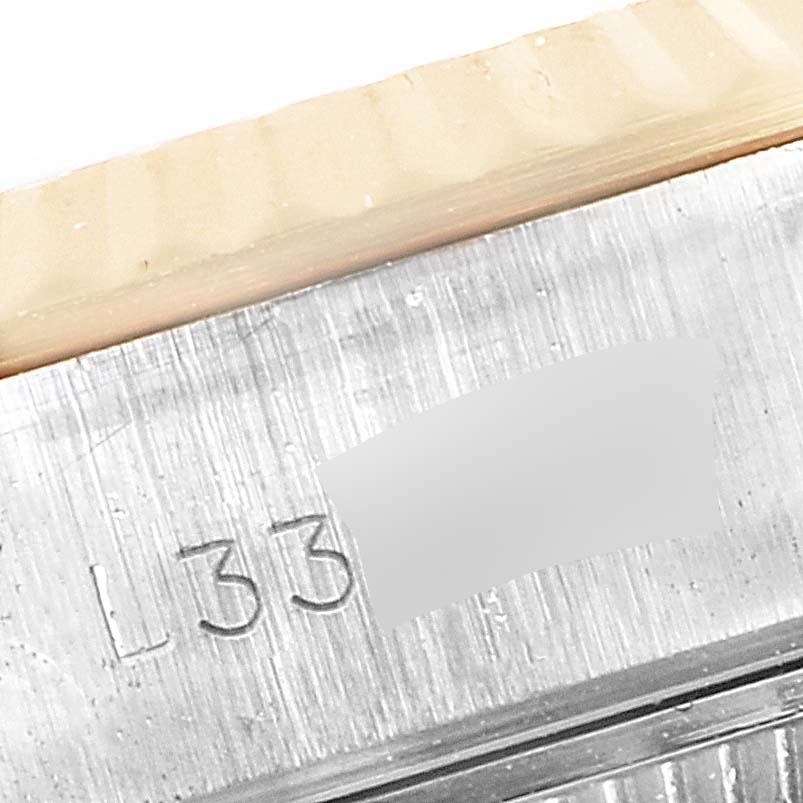 This image shows a close-up of the serial number engraving on the case of a Rolex Datejust 69173 Women
s Steel and Gold (two tone) Black Dial 69173 Women
s Steel and Gold (two tone) Black Dial watch.