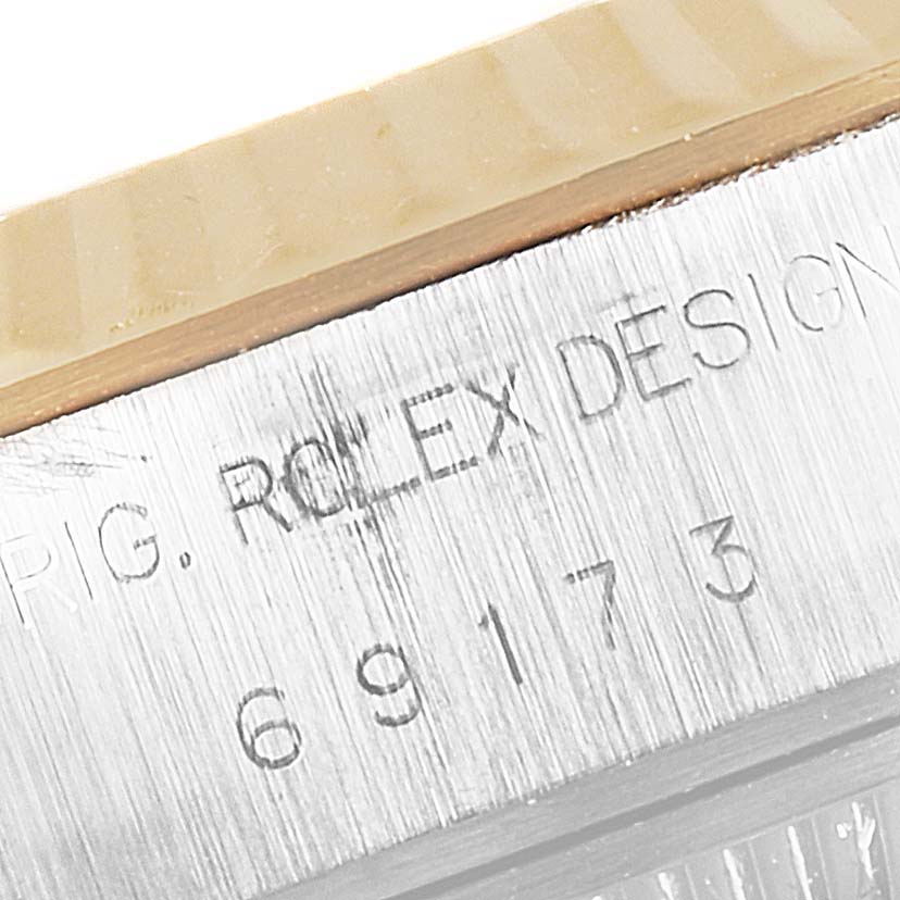 This image shows a close-up of the side of a Rolex Datejust 69173 Women's Steel and Gold (two tone) Champagne Dial 69173 Women's Steel and Gold (two tone) Champagne Dial watch, highlighting the engraved "ROLEX DESIGN" and the model number.