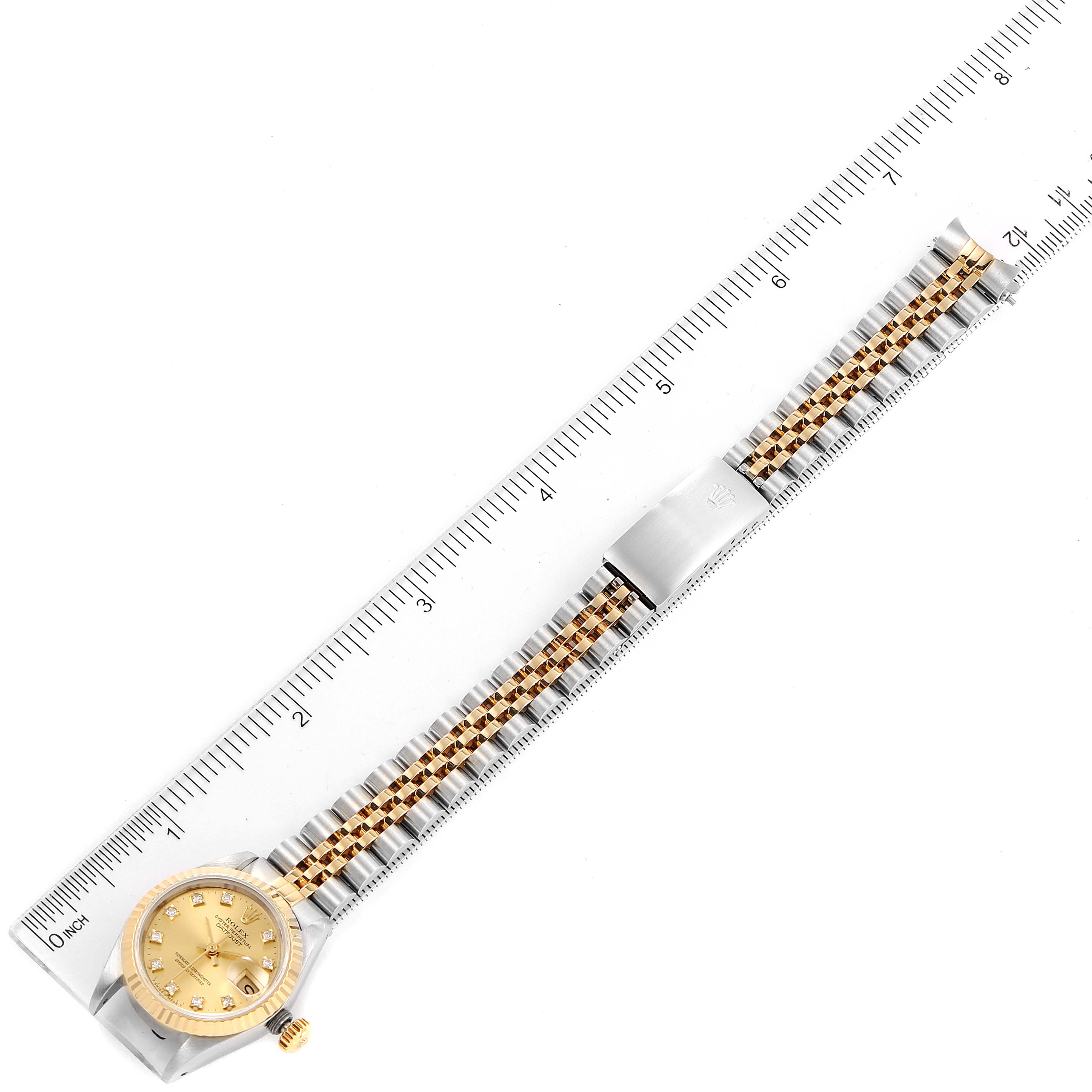 The image shows the full length of a Rolex Datejust 69173 Women's Steel and Gold (two tone) Champagne Dial 69173 Women's Steel and Gold (two tone) Champagne Dial watch, laid flat alongside a ruler for scale measurement.
