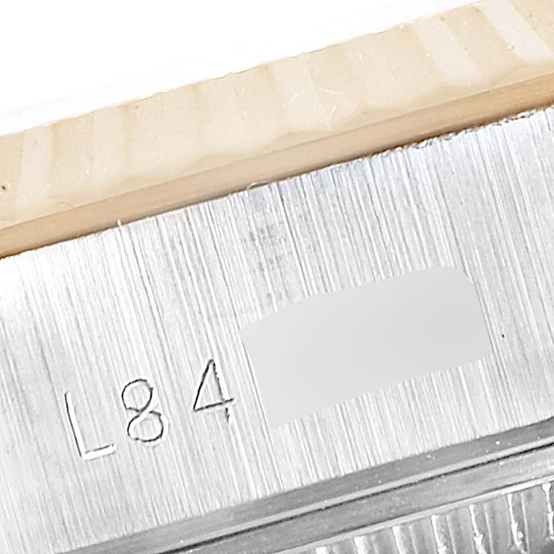 The image shows a close-up angle of the engraved serial number on the side of the Rolex Datejust 69173 Women's Steel and Gold (two tone) Champagne Dial 69173 Women's Steel and Gold (two tone) Champagne Dial watch case.