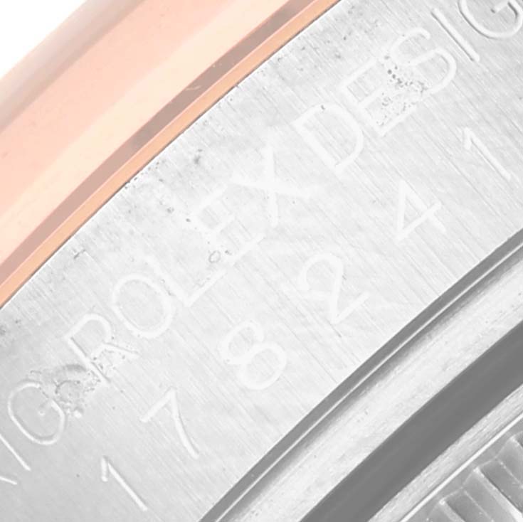 This is a close-up view of the engraved case back of a Mid-Size Rolex watch.