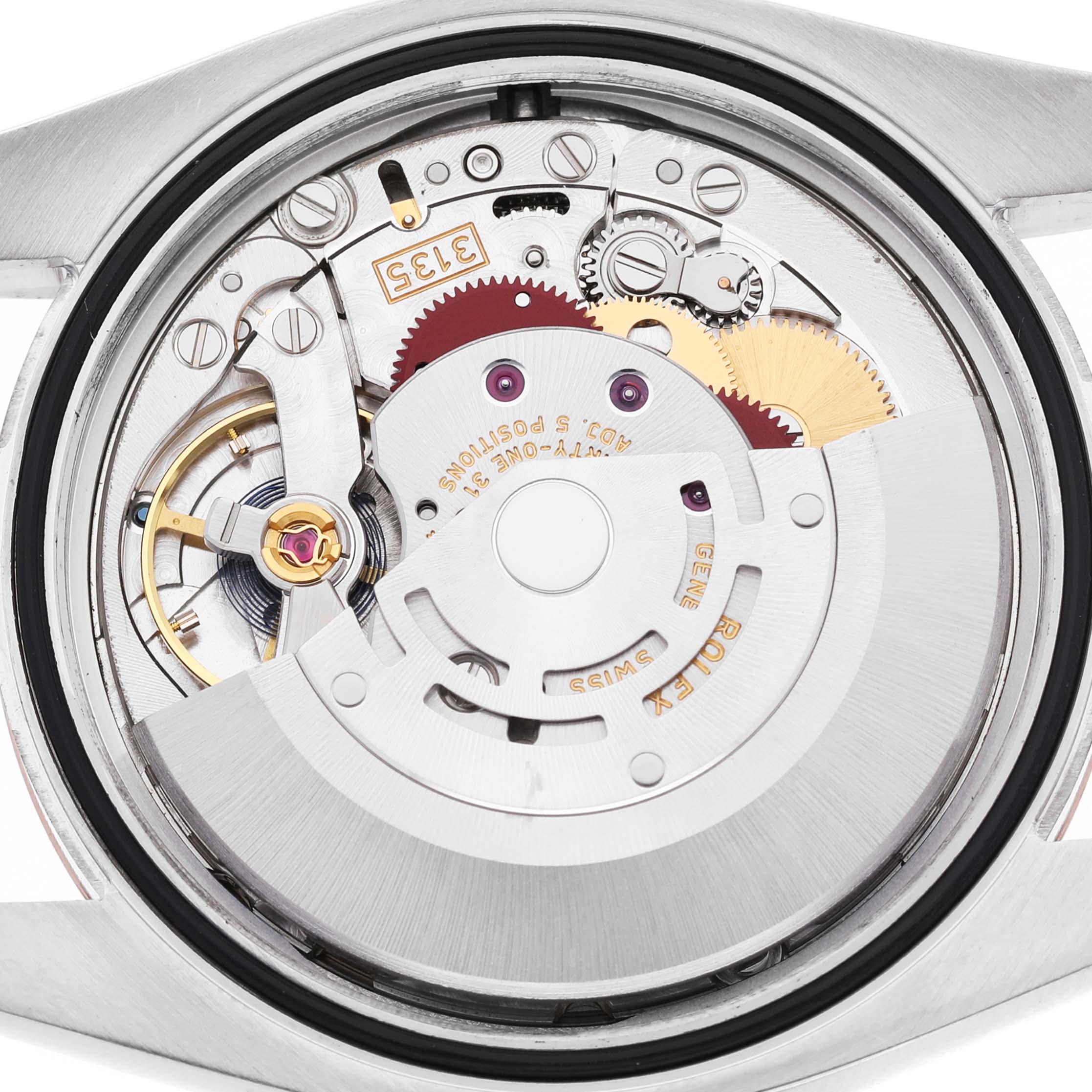 The image shows the internal mechanism of a Rolex Datejust 116231 Men's Steel and Gold (two tone) Mother of Pearl Dial, featuring gears and movement components.
