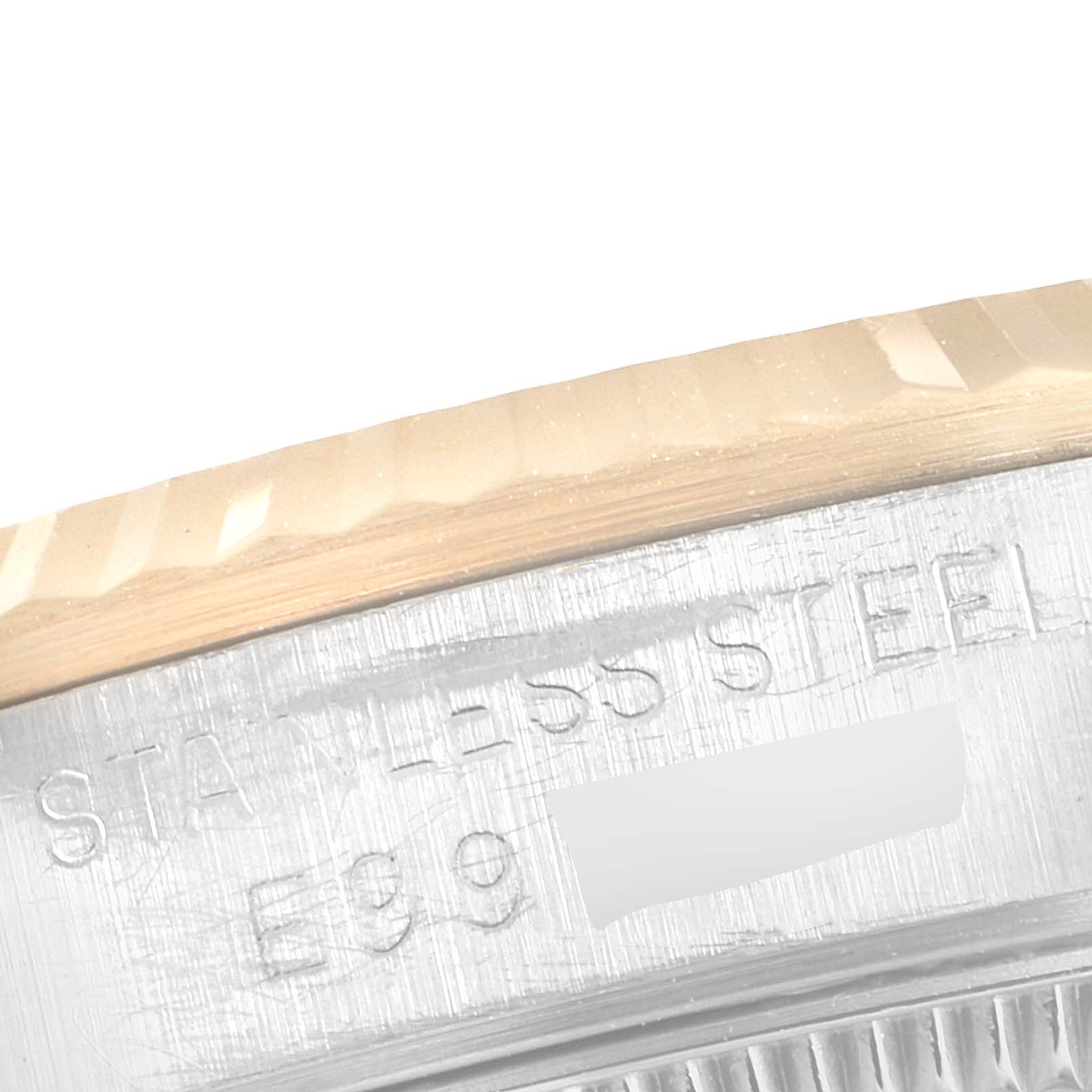 This image shows a close-up of the engraved side of the bezel and case of a Mid-Size Rolex watch.