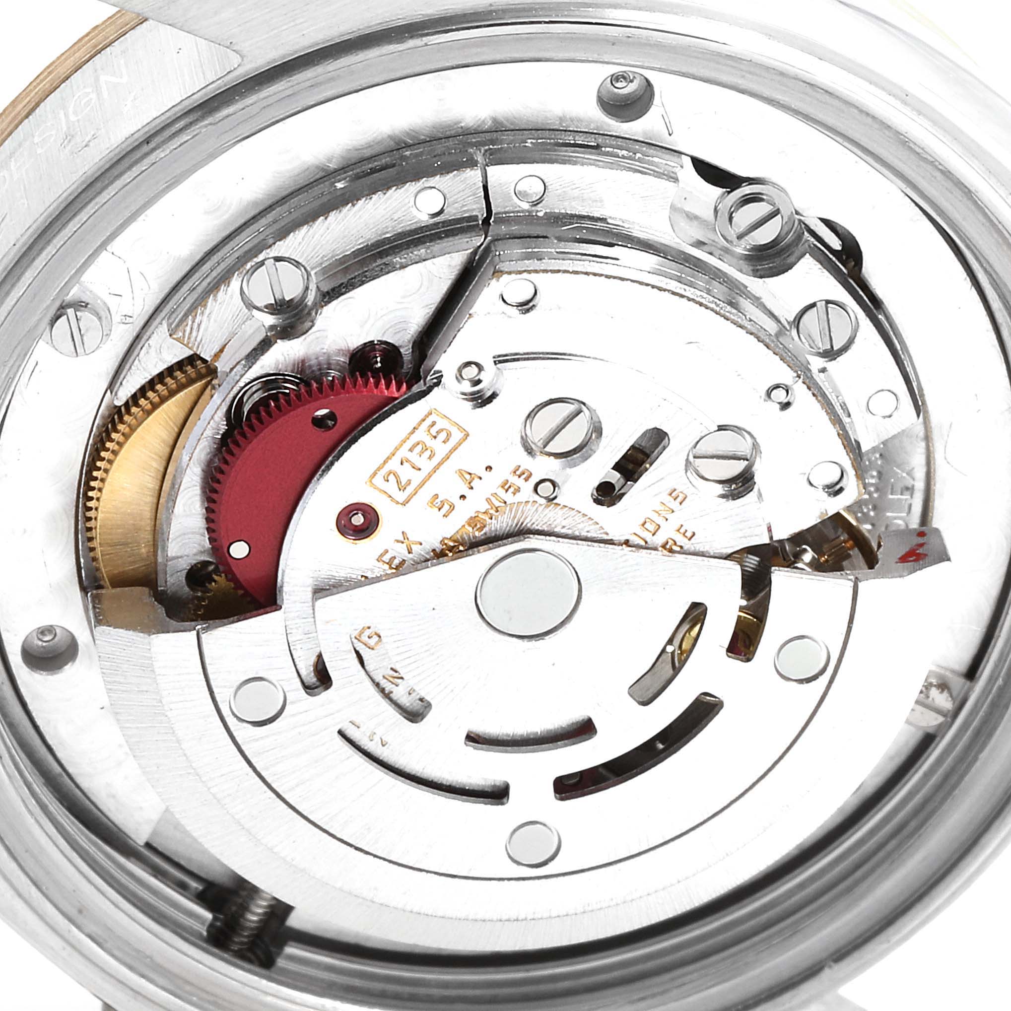 This image shows a close-up of the internal mechanism of a Rolex Mid-Size 68273 Women's Steel and Gold (two tone) Champagne Dial 68273 Women's Steel and Gold (two tone) Champagne Dial watch, including gears and other components.