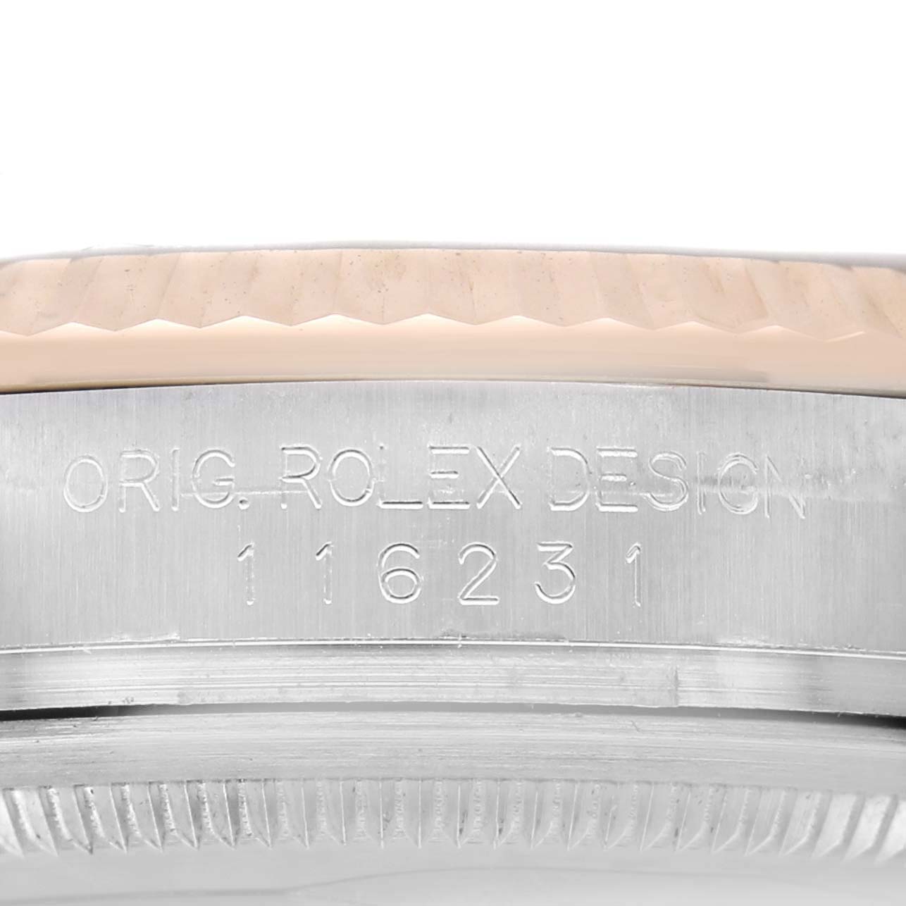 The image shows the side of a Rolex Datejust 116231 Men's Steel and Gold (two tone) White Dial watch, focusing on the engraved design number on the case.