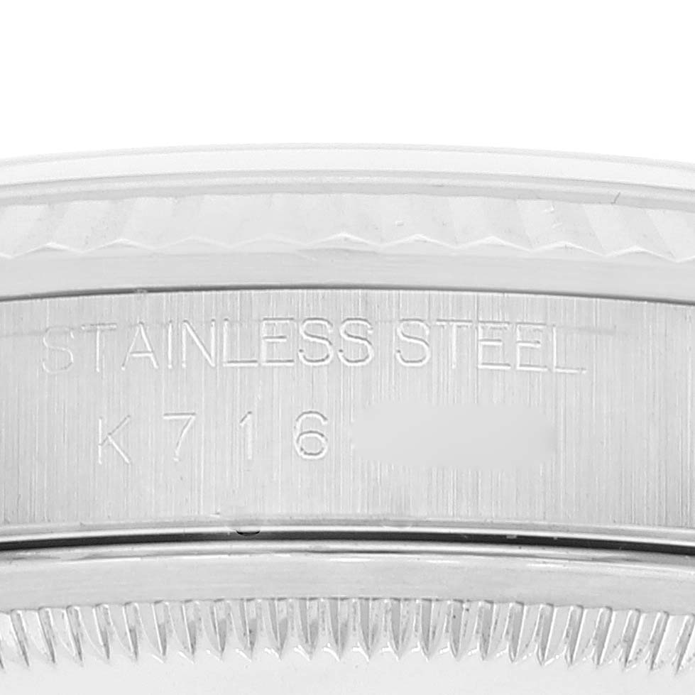 The image shows a close-up of the side of the case and the edge of the bezel of a Rolex Datejust 16234 Men's Stainless Steel Silver Dial 16234 Men's Stainless Steel Silver Dial watch, with engravings visible.