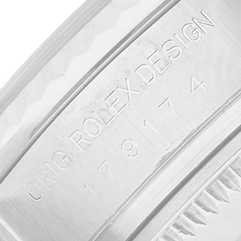 The image shows a close-up of the case back edge with engravings on a Rolex Datejust 179174 Women's Stainless Steel White Dial watch.