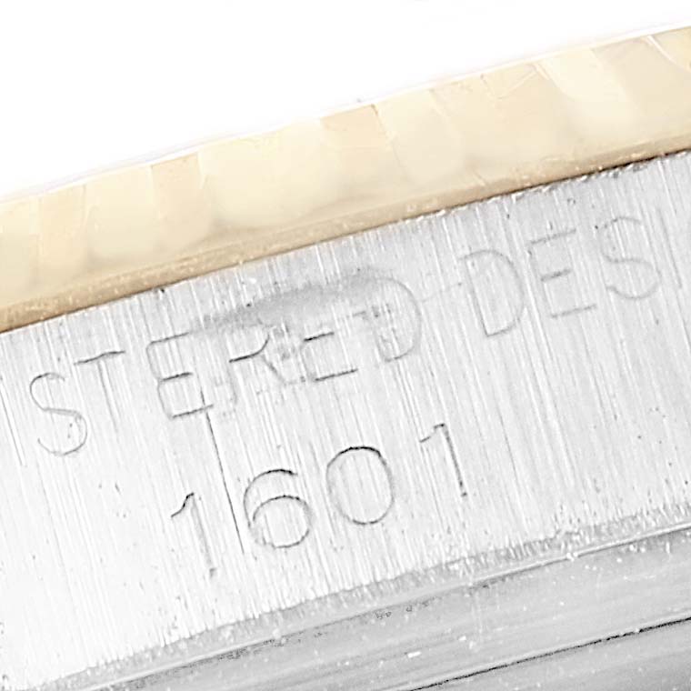 This close-up image shows parts of the bezel and case of the Rolex Vintage Collection 1601 Men's Steel and Gold (two tone) Champagne Dial 1601 Men's Steel and Gold (two tone) Champagne Dial model 1601.