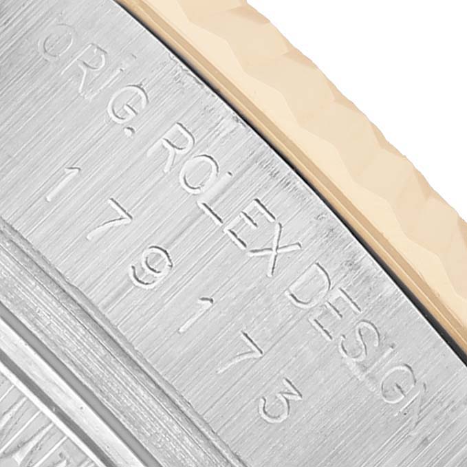 The image shows a close-up of the engraved side of a Rolex Datejust 179173 Women's Steel and Gold (two tone) Champagne Dial watch case, highlighting the model number "179173."
