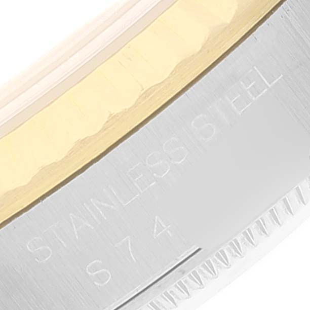 The image shows a close-up of the side of a Rolex Datejust 16233 Men's Steel and Gold (two tone) Champagne Dial 16233 Men's Steel and Gold (two tone) Champagne Dial watch, highlighting the stainless steel and gold bezel components.