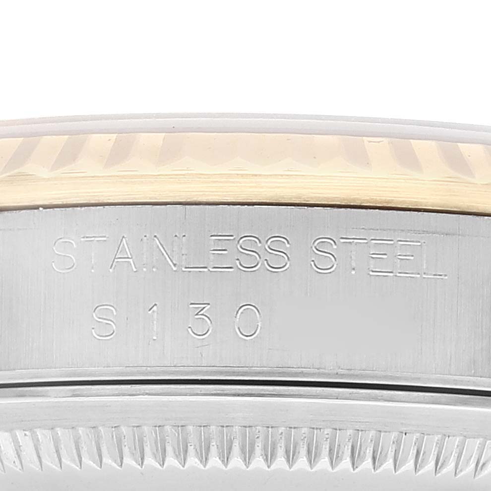 This image shows a close-up of the stainless steel case back edge of a Rolex Datejust 16233 Men's Steel and Gold (two tone) Champagne Dial 16233 Men's Steel and Gold (two tone) Champagne Dial watch, including part of the fluted bezel.