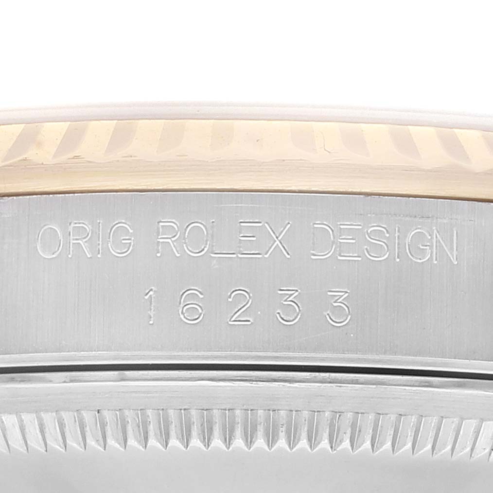 Close-up shot of the Datejust Rolex watch showing the engraved design model number "16233" and part of the fluted bezel.