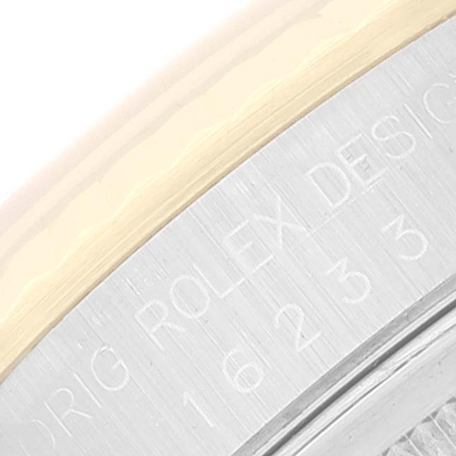 This close-up image shows the engraved bezel edge of a Rolex Datejust 16233 Men
s Steel and Gold (two tone) Grey Dial 16233 Men
s Steel and Gold (two tone) Grey Dial watch.