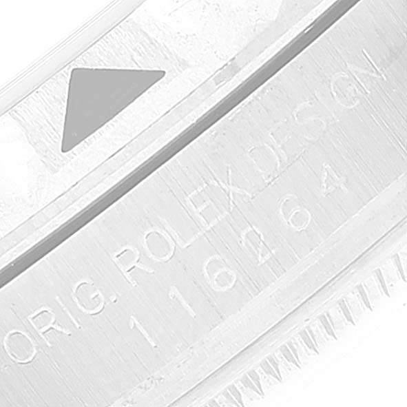 The image shows a close-up of the bezel and engraved serial numbers of a Rolex Turn-o-Graph 116264 Men's Stainless Steel Blue Dial 116264 Men's Stainless Steel Blue Dial watch.