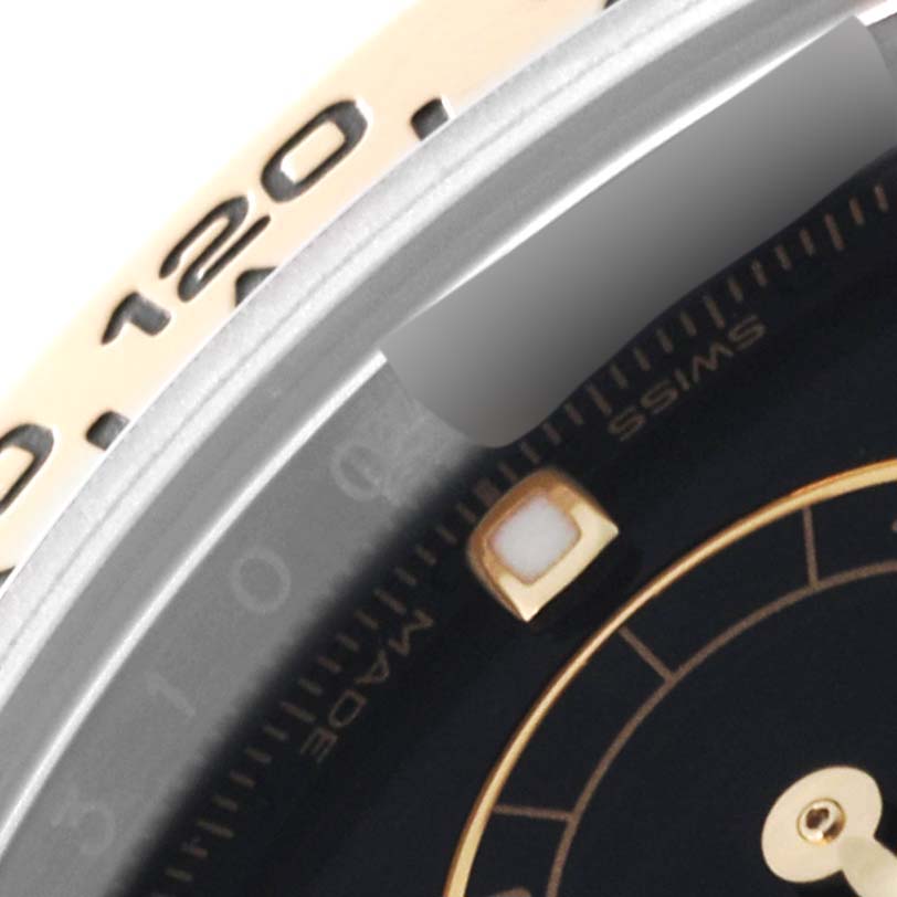 This image shows a close-up of the dial and part of the bezel of a Rolex Daytona 116503 Men's Steel and Gold (two tone) Black Dial 116503 Men's Steel and Gold (two tone) Black Dial watch.
