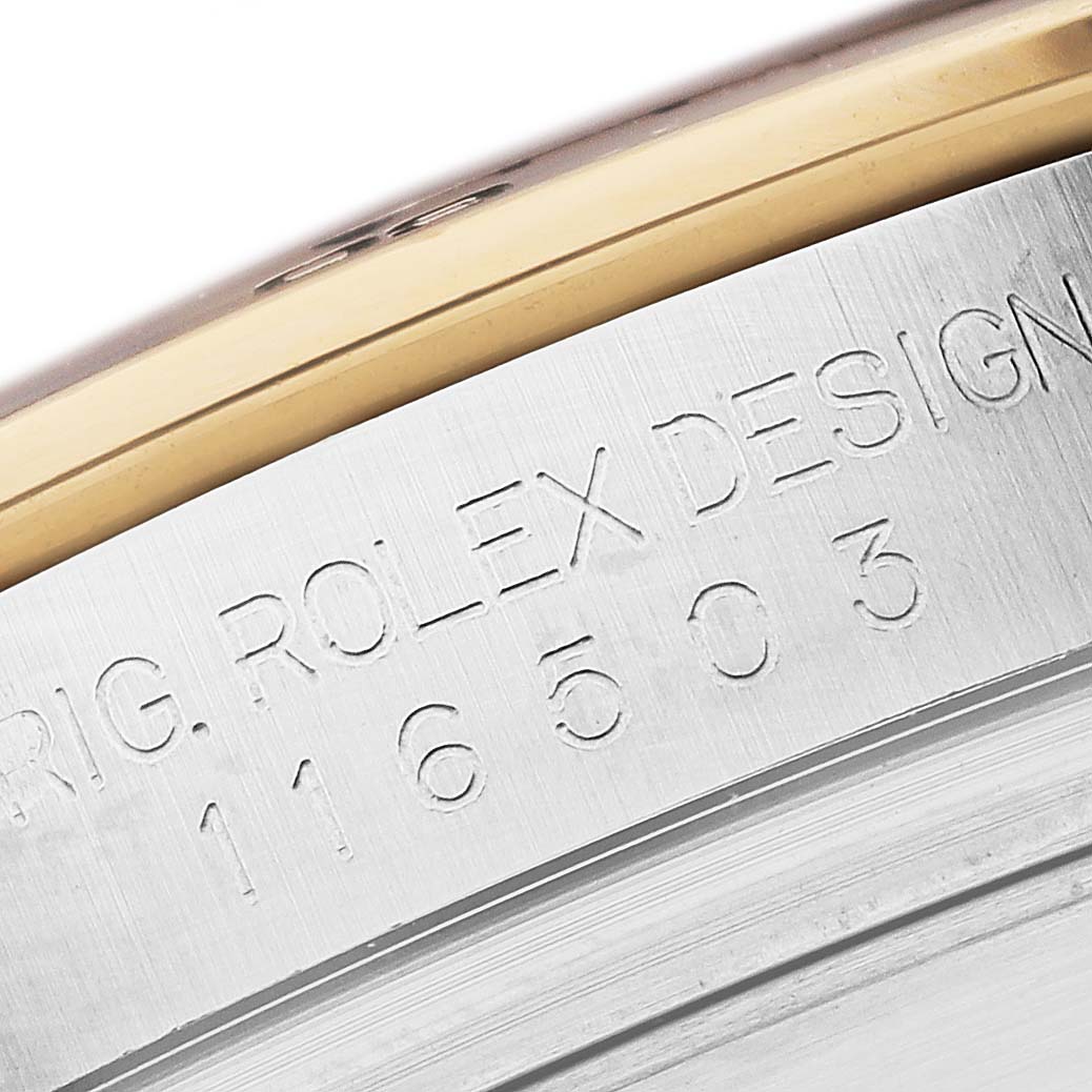This image shows a close-up of the engraved model number and "Rolex Design" text on the side of the Rolex Daytona 116503 Men
s Steel and Gold (two tone) Black Dial 116503 Men
s Steel and Gold (two tone) Black Dial watch.